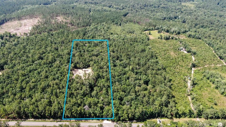 The perfect building site you've been waiting for that's in the country but not too far out of town. Just north of DeFuniak Springs (appx 10 min drive to downtown), with 7+ acres of lush land with a newly installed driveway. Full of hardwoods with a homesite has already been cleared, atop a hill which cannot be seen from the paved road. This property is special, so don't miss out. Seller will include fully engineered plans ready to go as a free bonus.