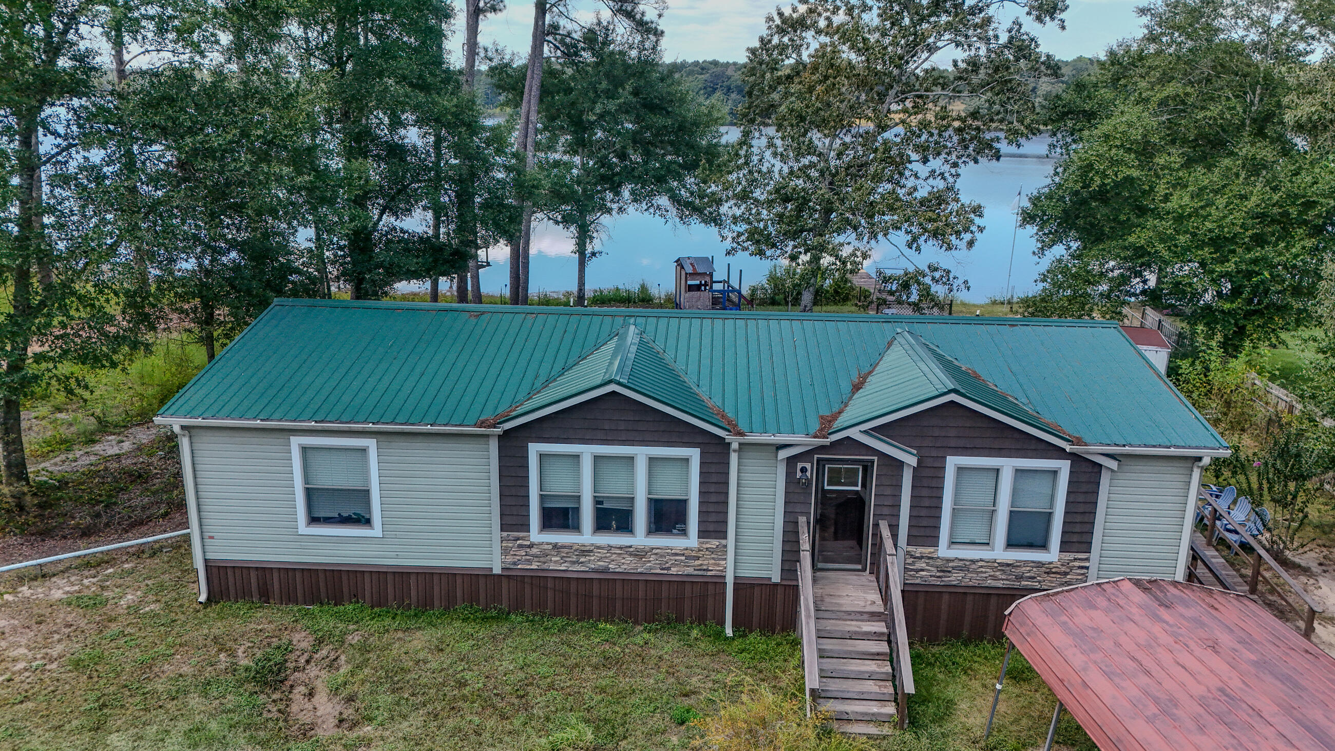 Affordable Waterfront Retreat! This nearly new 2021 home on Paradise Island Dr. sits on nearly half an acre with shady trees, a private dock, and sensational lake views you'll never get tired of. The split floor plan, eat-in kitchen with island and luxury vinyl floors make everyday living a joy. The master features a dbl vanity, walk-in shower and soaking tub. Outside you have the space to play, garden, or just relax with the breeze off the water. Paradise Island is a unique peninsula jutting out into King Lake, creating a tucked away retreat. King Lake offers appx 580 acres of world class fishing with black bass, crappie, shell-cracker, catfish and bream. Whether you're after a weekend getaway or full-time living, this spot checks all the boxes and leaves room for your own touches.