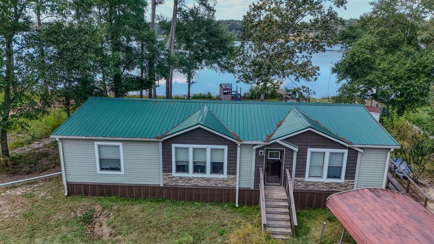 Affordable Waterfront Retreat! This nearly new 2021 home on Paradise Island Dr. sits on nearly half an acre with shady trees, a private dock, and sensational lake views you'll never get tired of. The split floor plan, eat-in kitchen with island and luxury vinyl floors make everyday living a joy. The master features a dbl vanity, walk-in shower and soaking tub. Outside you have the space to play, garden, or just relax with the breeze off the water. Paradise Island is a unique peninsula jutting out into King Lake, creating a tucked away retreat. King Lake offers appx 580 acres of world class fishing with black bass, crappie, shell-cracker, catfish and bream. Whether you're after a weekend getaway or full-time living, this spot checks all the boxes and leaves room for your own touches.