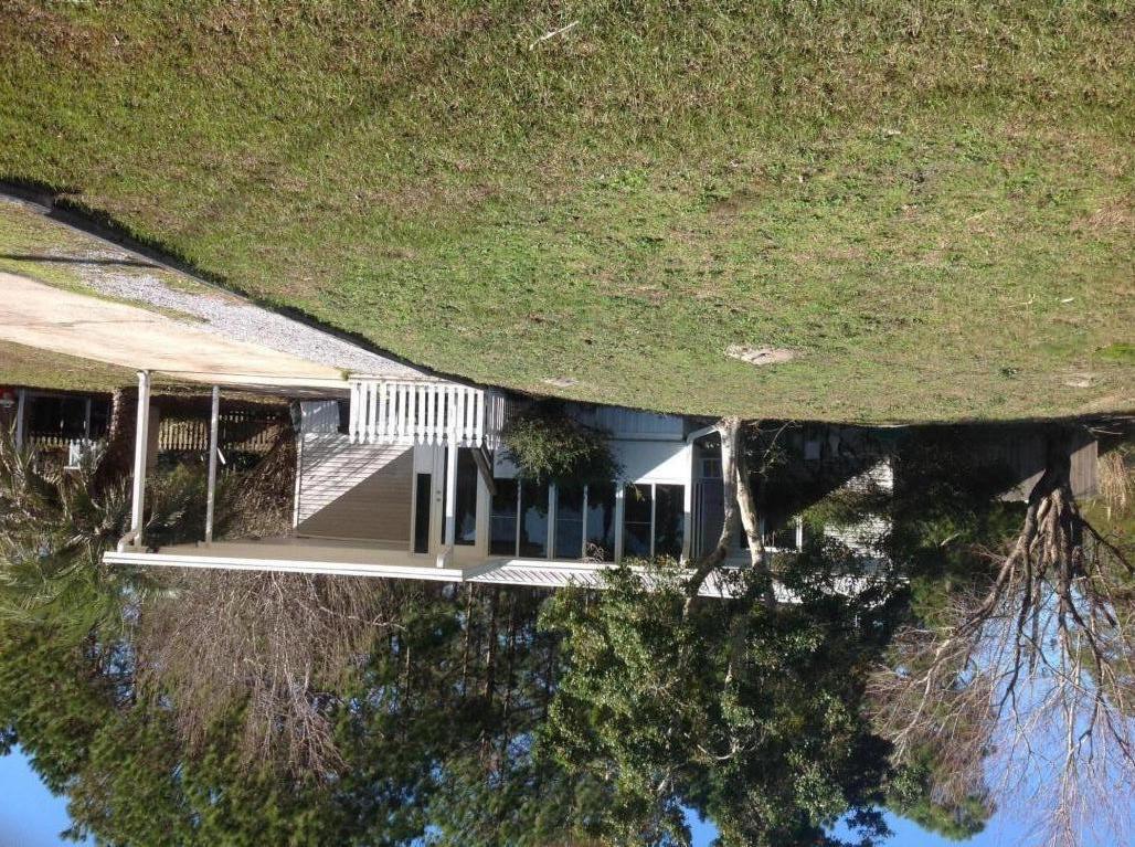Wonderful LOCATION on the South side of highway 98. Only 1.5 mile to Ed Walline Beach Access and Gulf Place. Close to Publix, dining, beach, shopping. Privacy fence new large back deck. Freshly painted. Large FL room heated and cooled on back and FL room on front of house has added an additional 400 + sq. ft. to the house, . New fridge and stove,metal roof 2012, HVAC 2021, water heater 2021 master bath updated 2013, guest bathroom updated 2014, 140 MPH rated windows all the way around the home, new flooring in kitchen, bathrooms and closets in 2017. Agent is owner of property. Great community. Florida room has a closet so can be used as a 3rd bedroom.