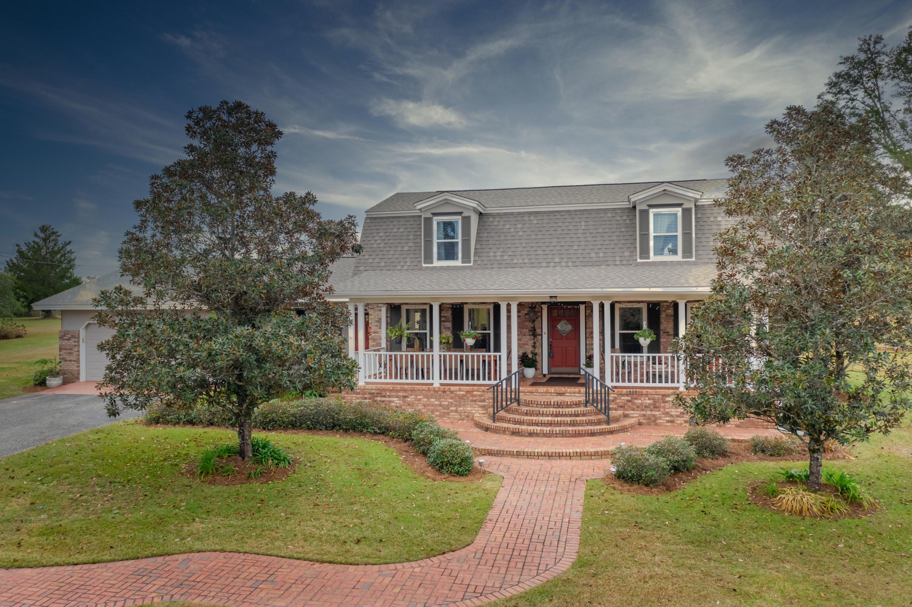 SELLER TAKING BACKUP OFFERS.This is the beautiful home and 19 acres you've driven by and admired for years! The breathtaking tree lined paved driveway guides you to your new home in the country, but just close enough to the city. The impressive sized front porch might make you wish you had a glass of sweet tea/etc. and a book to relax with. Enter the foyer area to be impressed with all in site. Your new wood floors will lead you to the right side which is the Boar's Den, aka, the den. To the left is the gorgeous dining room that adjoins the remodeled kitchen. Between the two rooms you are awarded an eat-in bar with storage galore, topped with granite counters, and probably has enough seating area for all your best friends for a fun night of entertaining. Move into the Princess Parlor, aka, the living room, to cozy up to the hearty fireplace and views of your glorious land. Off the parlor you have an oversized laundry room with office space, an abundance of storage, and a full bath. Across the way you will find the first master bedroom next to the full bath that includes a new glass enclosed shower/bath combo. Feel royal with bidets in all the bathrooms. Upstairs is impressive with 3 bedrooms and a full bathroom. One of the bedrooms is a second master suite with a full bath that includes a separate guest entrance (unless you lock that door). Also has an attached vanity room. Here's some of the new items: Roof 2019, one of the two HVAC units 2018, windows 2016, downstairs remodel 2014, exterior paint 2017, microwave 2016, glass tub/shower enclosure in downstairs master bath 2017, weather stripping on all doors 2020, porch ceiling fans 2018, wrought iron rails on front porches, and irrigation system updated 2017. Bonus features: back entertainment patio area that spans almost the entire length of the home, termite bond in place, pole barn, garden spot with electric fence, chicken coop (you might negotiate some chickens), 2 car garage, and a very impressive barn with an attached but separate cooled summer kitchen and living room area. The location is perfect as the home is within 2.5 miles to the hospital, shopping, dining, and schools, around 5 miles to Falling Waters State Park which is home of Florida's tallest waterfall, and within around an hour to the international airport and the sugar white beaches of the Gulf Coast. Call...don't let someone else take your home!