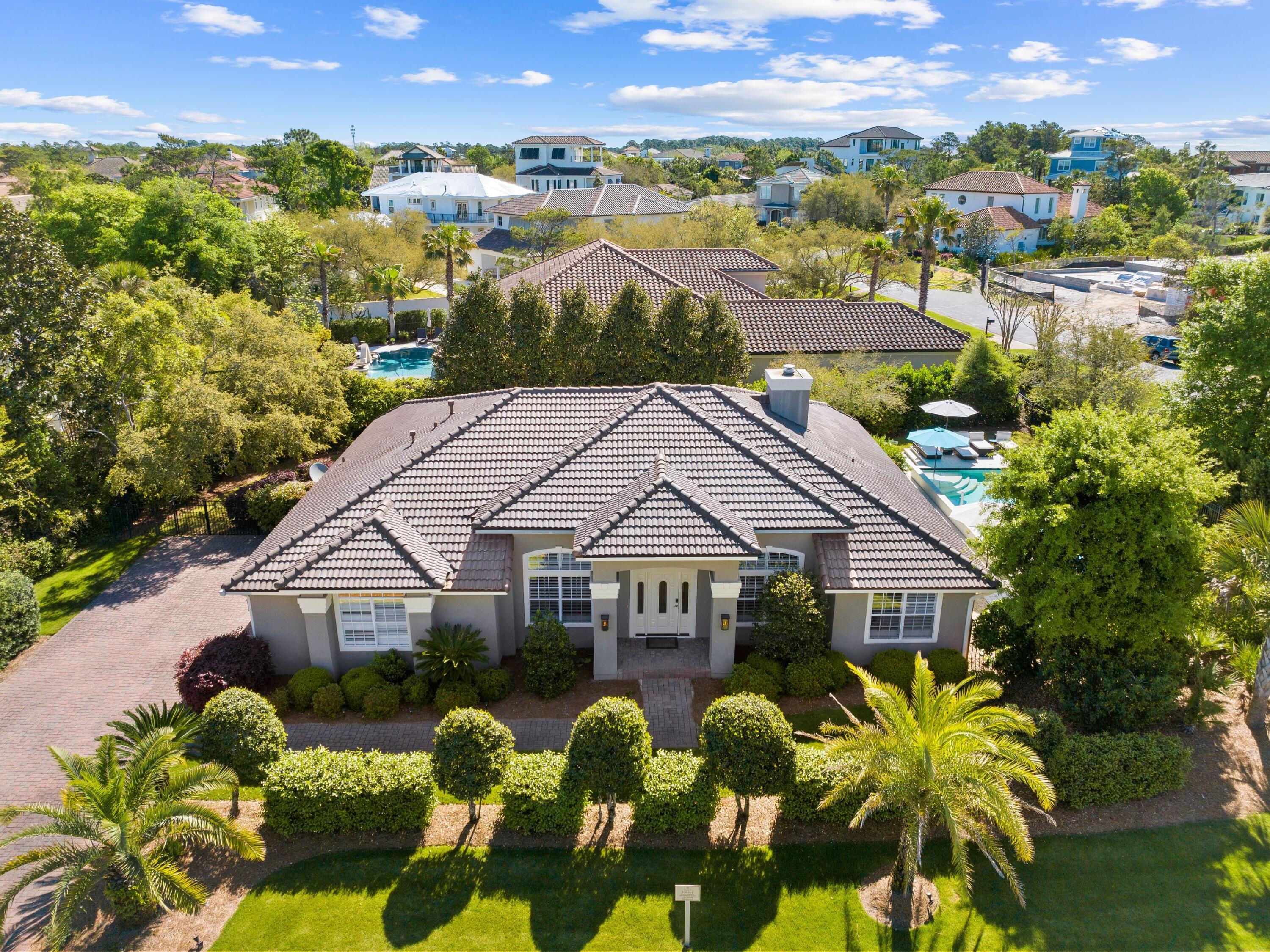 Comprehensively renovated and expanded home in BellaMar close to neighborhood private beach access. This fully furnished coastal residence will exceed expectations, inside and outside, with an expansive, heated pool and new roof added in March 2024. Occupying a generous corner lot, this impressive home has a lengthy driveway and a two-car garage. The pillared entrance porch opens into a huge contemporary living space that will take your breath away. New flooring throughout the home provides a backdrop for the neutral decor and modern furnishings arranged in this spacious home. There's a dedicated office space on one side and a built-in wet bar with its own wine cooler and ice maker. It's perfect for serving drinks to guests before heading into the separate formal dining area.