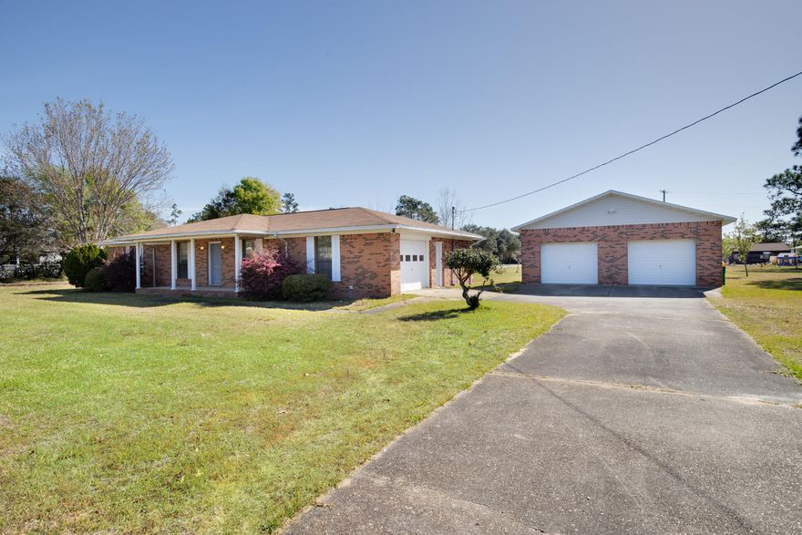 LOOKING FOR AN AFFORDABLE ESTATE SIZE, 1 ACRE LOT, W/HOME, CLOSE TO EVERYTHING? You've found it. Enjoy the privacy & tranquility of the country, w/the convenience of being just minutes away from schools, shopping, restaurants & the beach! Offering a ''Dream'' 784 SF detached 2 car garage, PLUS an attached 1 car garage, there's plenty of room to house your boat, RV, 4 wheeler & extra vehicles! 2005 Roof provides updated wind mit credits. 4 Yr old water heater & 6 yr old HVAC provide peace of mind. Other features include 2 living areas, fresh interior paint, new light fixtures, exterior workshop building & washer & dryer. A large, covered front porch & back patio allow you to enjoy your acreage & Florida lifestyle. Act now, as this opportunity for acreage close to town won't last long.