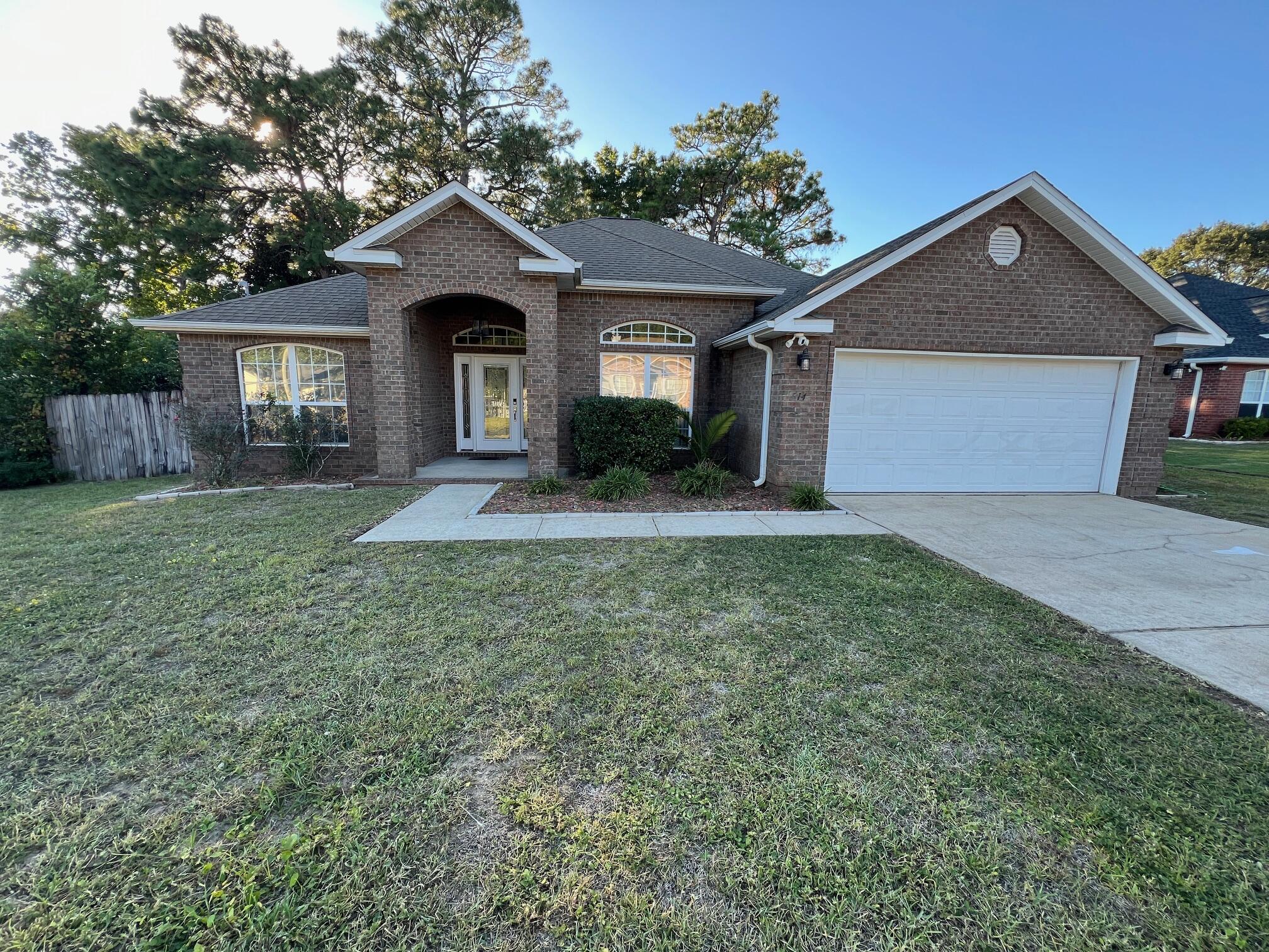 Nestled on a quarter acre lot in the heart of Fort Walton Beach - Close to Bases, Beaches and Shopping! This stunning all-brick 4-bedroom, 2-bathroom home offers a blend of elegance, comfort, and functionality. Step inside and be greeted by soaring 10-foot ceilings in the main living area, complemented by trayed ceilings in the dining room and master bedroom. The open floor plan features no carpet, with beautiful tile and luxury vinyl plank (LVP) flooring throughout, ensuring durability and ease of maintenance. The expansive living room, accentuated by a cozy gas fireplace, seamlessly flows into the gourmet kitchen, which boasts top-quality wood cabinets, sleek quartz countertops, and a convenient breakfast bar--perfect for entertaining or casual family meals. The Large Master Suite The Large Master Suite serves as a serene retreat, featuring a private entrance to the covered patio, a spacious walk-in closet, double vanities, a luxurious jetted garden tub, and a separate walk-in shower. The split bedroom layout offers privacy, with the fourth bedroom easily convertible to an office or guest room.
Additional highlights include:  Three well-proportioned guest bedrooms and a shared full bath; a functional laundry room complete with washer and dryer included; An oversized 21' x 23' 2-Car garage for ample storage and parking; A fully fenced backyard that invites outdoor gatherings, complete with a fire pit surrounded by pavers for cozy evenings, and a sprinkler system with automatic timer to keep the lush yard looking pristine.  Located Centrally between Hurlburt Field and Eglin AFB.  Call to View it today!
