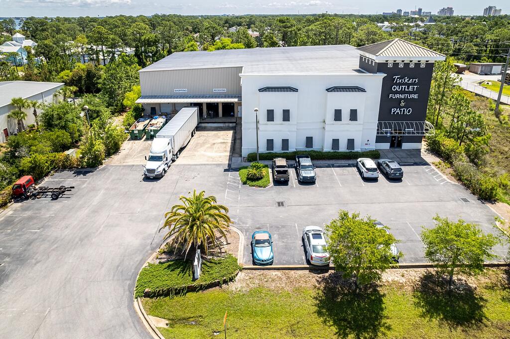 This subject listing offers the Tusker's warehouse, excluding the freestanding retail building fronting Highway 98 (freestanding retail building also available via MLS 978842). This rare assemblage of prime retail, showroom, and warehouse does not currently exist in the local market, which is adjacent to the synergistic retail nucleus of Silver Sands Premium Outlets and centralized to all the local mixed-use districts, successfully drawing population from all local peripheral sub-markets, including but not limited to Destin and Scenic 30A of Santa Rosa Beach, Florida. Fronting Highway 98 in Miramar Beach, nearly 50,000 vehicles pass by its 196 fronting feet daily, which ingress and egress lures the traffic into the retail facilities through the convenience of... the traffic light at N. Geronimo Street and Highway 98. The current owner has committed significant capital to renovate both buildings, which even includes approximately $300,000 for new escalators to service the second floor of the main showroom. Parcel 1 contains a two-story building, oriented on ??1.18 acres, hosting prime retail and showroom space, as well as private offices, collectively measuring ??26,893 conditioned square feet. There is a 3rd floor that accommodates a spectacular executive office, accessible via a private & secured "floating" staircase. The structural integrity of the building is phenomenal, and the finishes throughout are exceptional. Parcel 2 contains a warehouse, office, and showroom, situated on ??2 acres, and constructed in 2004, measuring ??11,282 SF on two floors. The warehouse contains a broad loading dock area and massive rack system with a lift and guide rails. Both buildings project an architecturally magnificent image. This opportunity is irreplaceable locally, as land development code would neither accommodate this massive yield, nor would a developer endeavor upon such a project, as the inflationary costs of this era, coupled with land costs, (even if such prime vacant land at a traffic light were available, which is non-existent), would likely much exceed $20,000,000+. The current business is operating a record-breaking levels, year over year; thus the attributable value to this extremely prime site and assemblage is likely understated. All showings are by appointment only and require a minimum of 48+ hours advanced notice. The listing broker must accompany all showings. Financial credentials are required prior to confirmation of any showings. Please do not approach any onsite staff.