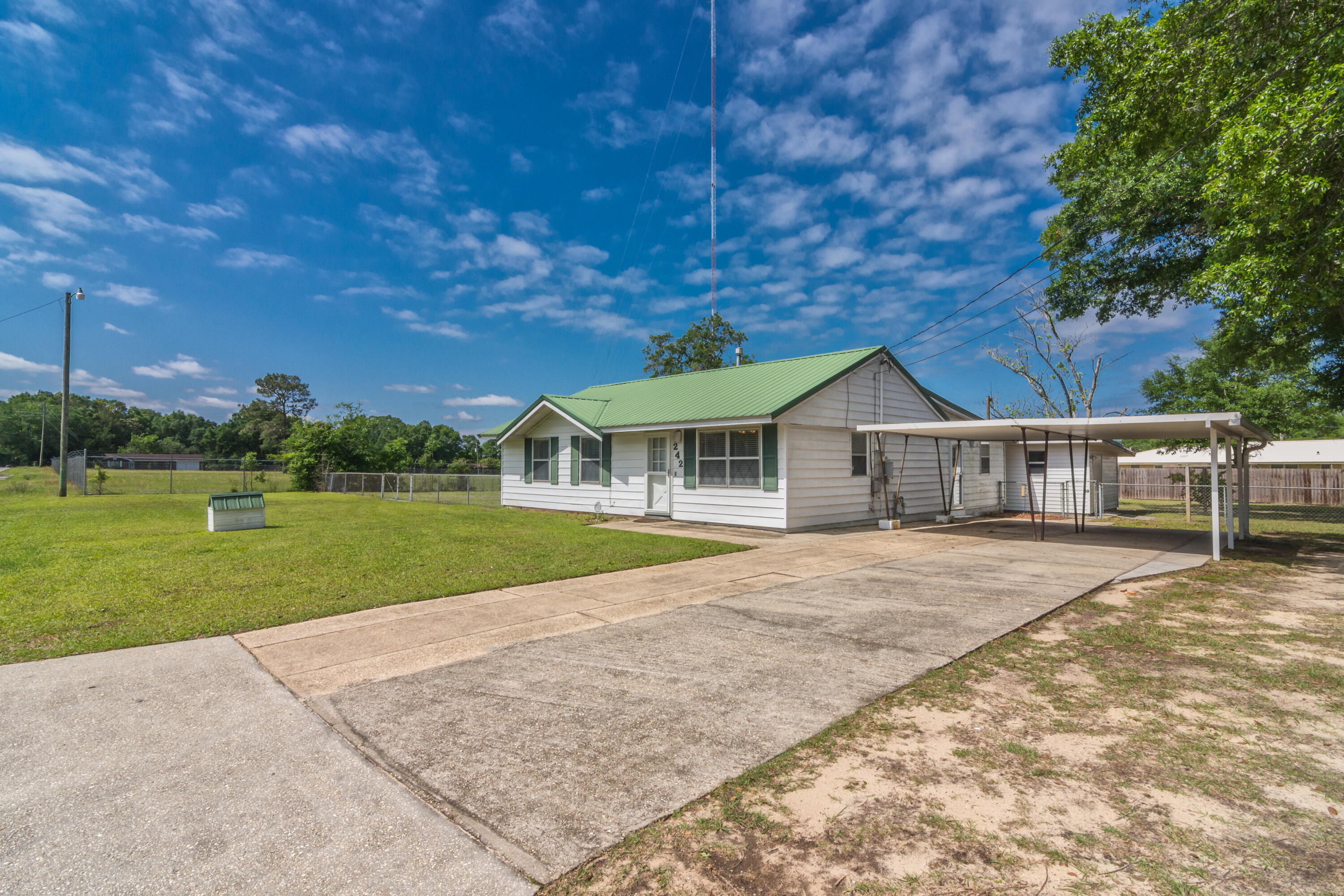 Well maintained 4 bd/2 ba home 'with good bones' situated on a half acre lot!! NOW - It's time to roll up your sleeves and make this your very own with a personal touch from YOU!! The home has lots of great space including a living room and separate den area, functional kitchen, adjoining dining area and nice sized bedrooms. The home features a large screened-in back porch and large covered carport to one side. A workshop is located on the property as well. PROPERTY TO BE SOLD IN 'AS IS' CONDITION. (The property consists of 6 (25') lots...the home sits toward one side and the property could be potentially split out to produce another separate lot. Agents and owners make no guarantees of this potential split. Buyer to verify and satisfy themselves as to this information.)