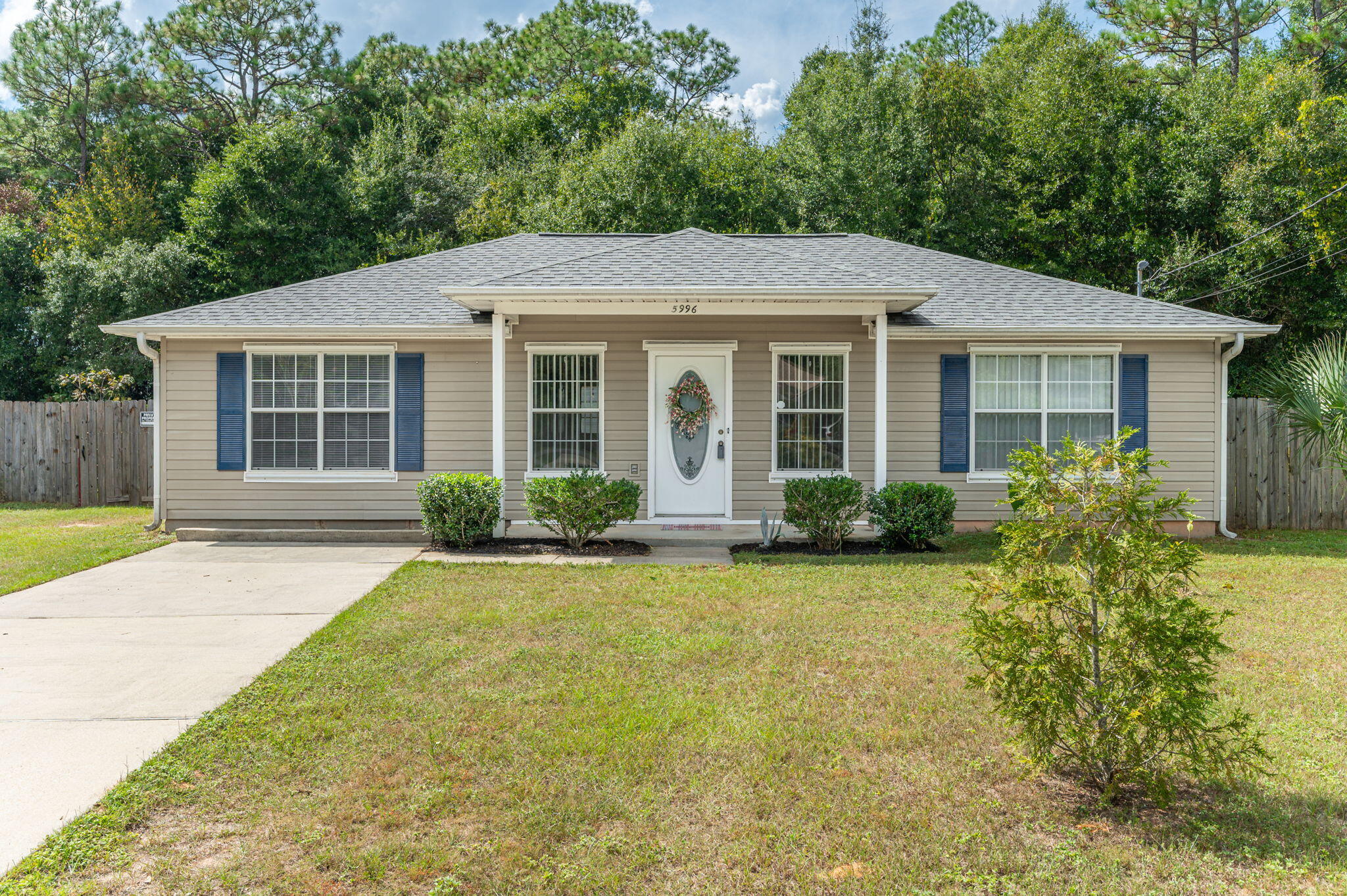 Welcome home! Tucked in a quiet loop-style neighborhood accessible from Dogwood Drive or Stewart Street, this home blends charm, comfort, and convenience. You'll love the farmhouse-inspired kitchen with reclaimed-style whitewashed wood paneling, butcher block counters, stainless steel appliances, and a spacious island bar. The split floor plan offers privacy, and the primary suite features a double vanity and soaking tub. Relax on the covered back patio overlooking the privacy-fenced yard with a 12 X 24 aluminum storage building. Gutters & downspouts and a 2023 roof, move-in ready and easy to love!