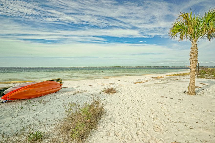 Welcome to Navarre Beach! Stunning 4 bed, 2 1/2 bath beach home in a gated community ''By The Sea'' with access to private beach on the sound, community pool, hot tub and fire pit. The main floor has tall ceilings, crown molding, hardwood floors featuring a large open kitchen, dining and living area. The kitchen has a large island with granite counter tops, an elegant backsplash, soft-close wood cabinets with under cabinet lighting, and stainless steel appliances. The 1st floor also features a powder room and a guest bedroom. The 2nd living floor has a large master bedroom with a luxurious master bath, large closet, and 2 guest bedrooms and a full bath. Large balconies, and storage. 3 blocks from the beautiful emerald waters of Gulf of Mexico. Great investment opportunity-rental potential.