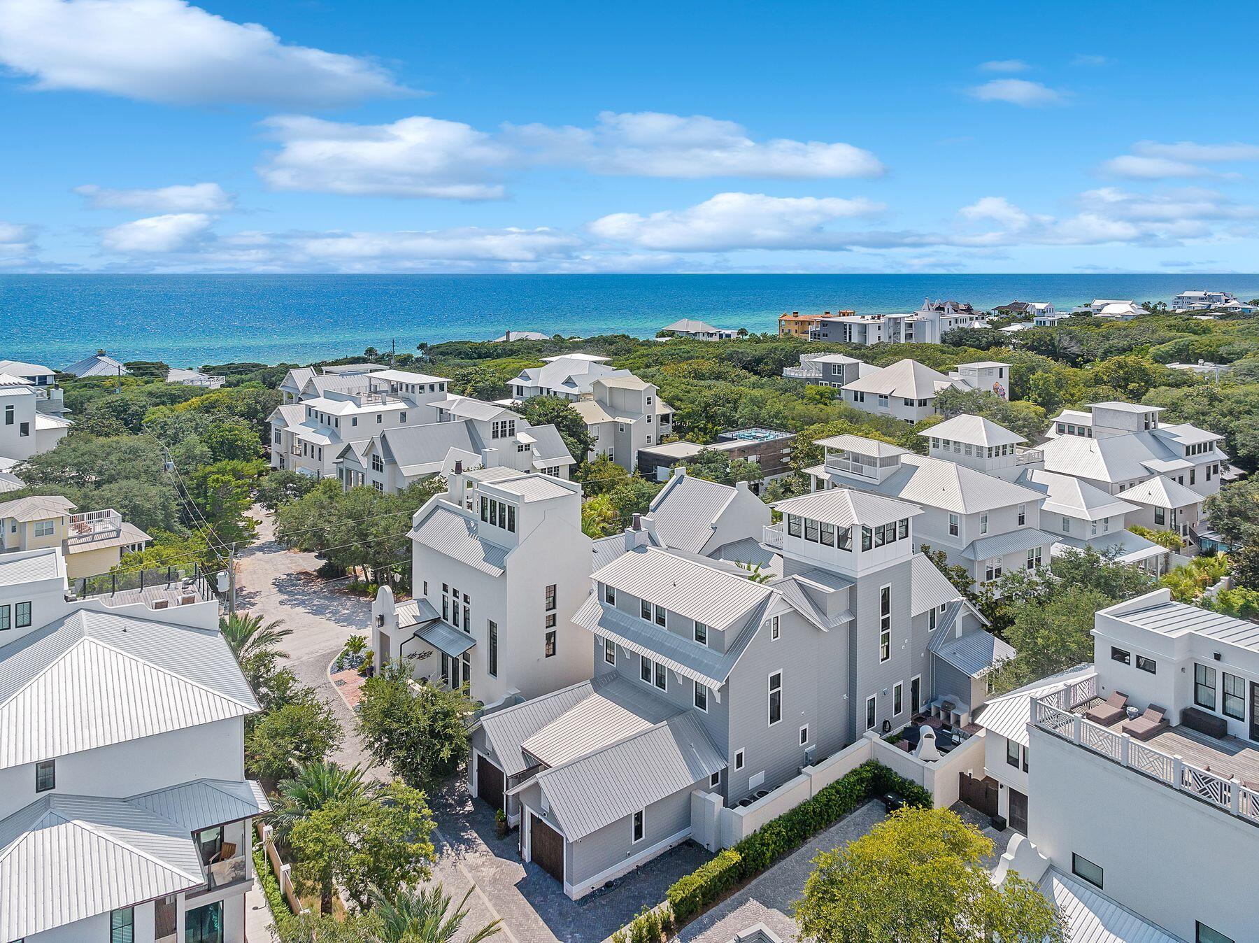 Nestled in the charming neighborhood of Old Seagrove, this exceptional custom home is a true testament to craftsmanship and design. It spans an impressive four levels, featuring five spacious bedrooms, each thoughtfully equipped with its own ensuite bathroom. Evening gulf views from the top-floor tower complete a wonderful day. As you step into the foyer and enter the main level of this exquisite home, you are immediately immersed in the artistry of custom trim and millwork, meticulously crafted from rare black cypress found rarely in homes here on 30a. Throughout the residence, six-inch white oak plank flooring creates a timeless backdrop, seamlessly connecting all of the living spaces.