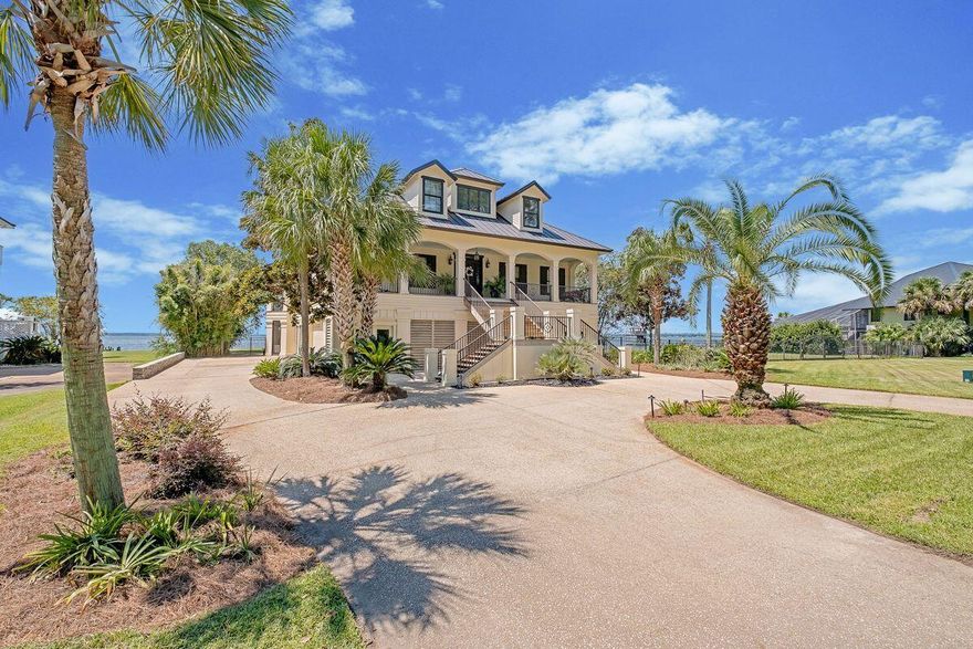 Salt + Serenity Home offers an unrivaled waterfront lifestyle on Escambia Bay with sweeping 270 views. Located in the exclusive Bayside North Island community, this elegant estate features an elevated, landscaped lot, circular drive, and grand entrance with classical arches. Inside, find soaring hand-painted ceilings, pine floors, and a spiral staircase leading to a bonus bistro area. The chef's kitchen includes a granite island, gas range, and custom cabinetry. Living areas showcase bay views, a fireplace, and formal dining. The primary suite is a retreat with spa bath and French doors to the water. Outdoor perks include covered decks, a screened lanai, and deep-water access--ideal for boating and entertaining.  This isn't just a home--it's a legacy, a retreat, schedule your tour today.