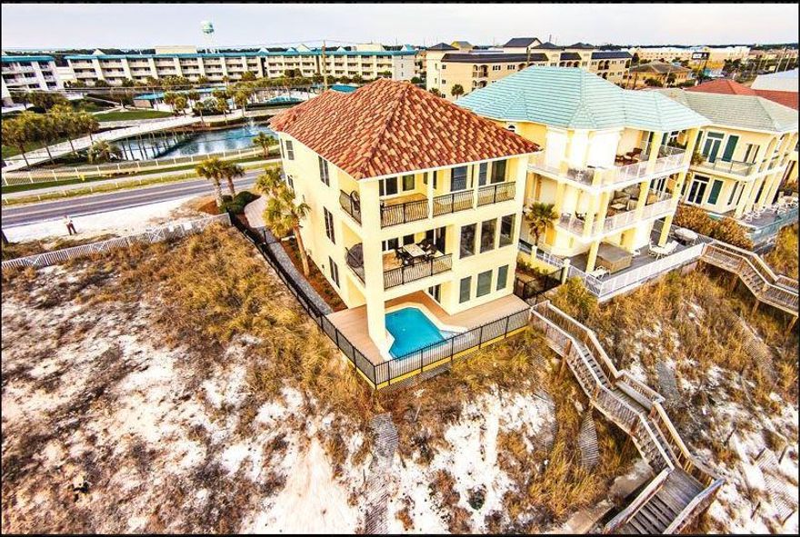A rental powerhouse! Over $200,000 annual gross revenue in 2017, and already over $200,000 2018 YTD.This elegant home features a Gulf Front pool, two fireplaces, Travertine floors, elevator, gulf-side guest suite with private entrance, 3 gulf front balconies, 2 car garage, professional landscaping, and an armored seawall. Home is 32 feet above sea level. Many of the exquisite upgrades include granite counters, marble accents, sound system, stainless steel appliances, security system and unique lighting. Home sits high on a bluff with unobstructed South and West views!