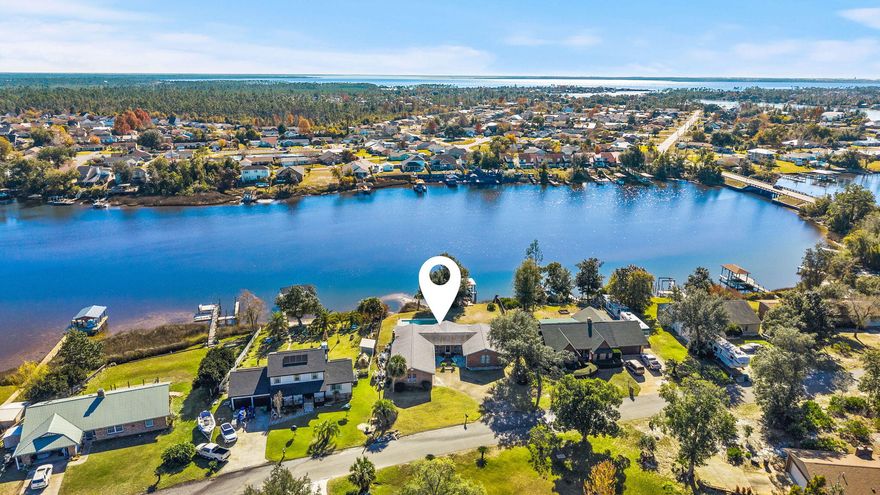 Welcome to this beautifully renovated 4-bedroom, 2-bath waterfront home offering the perfect blend of modern updates, coastal charm, and true Gulf-access living. With 100 feet of water frontage, a private boat dock, and a boat lift, this property is ideal for anyone who wants to enjoy life on the water. Step inside to find updated flooring, fresh interior paint, and a bright, airy layout filled with coastal vibes. The kitchen has been recently upgraded with modern cabinets, sleek countertops, and newer appliances, delivering both style and function. The spacious master suite features a generous walk-in closet and plenty of natural light, creating a peaceful retreat. Additional highlights include newer lighting throughout, making every space feel refreshed and inviting Outside, enjoy your own backyard oasis with an inground pool installed in 2022, perfect for entertaining, relaxing, or cooling off after a day on the water. Located close to shopping, restaurants, schools, churches, and Tyndall AFB, this home offers incredible convenience while providing the coastal lifestyle buyers are searching for. Move-in ready, updated, and on the water, this one truly has it all!