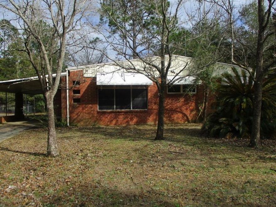 Centrally located in the Heart of Crestview, this 1955 REO property has all brick exterior, attached carport and tons of potential. 1264 square feet with 3 bedrooms and 1 and 1/2 baths. Home has vinyl tiles, original wood floors, carpet, some paneling and solid wood cabinets. Home is walking distance to schools, ball fields and local shopping. A must see to appreciate. Please call with questions or to see this home!