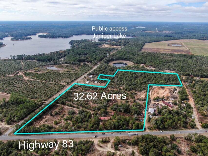 32.62 acres of prime heavy industrial property with a completed home. There is absolutely no end to the potential in this property. This rare corner lot has 1000 feet of frontage on Highway 83 and full access off Cat Island Road and Cordie Redmon. Lot is located in one of the quickest developing areas of DeFuniak Springs. Changes are happening over night and the community is ripe for new commerce. Defuniak Springs is located on the Florida Panhandle, halfway between Tallahassee and Pensacola. US 331 was widened to 4-lanes, which has enhanced economic growth and provides improved accessibility for commercial traffic. The subject property offers a great opportunity for a developer. Strong enough traffic patterns to warrant a new Family Dollar, Large Manufacturing Plant or restaurant chain.