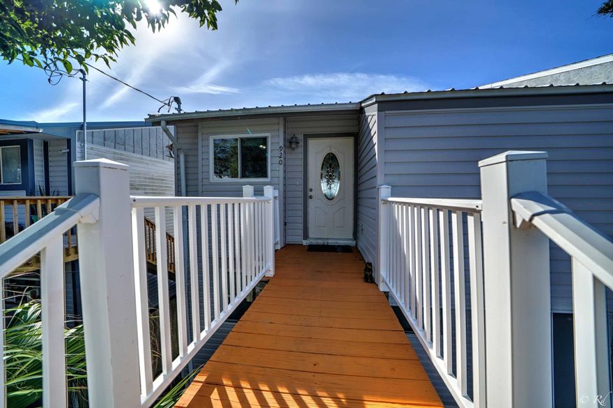 PRICELESS SUNSETS! 3 bed/2.5 Waterfront townhome in Parker. Decking leads to the front entrance and down to the backyard where there is Bay access. Perfect for paddle boards, pontoons and small boats. There is a covered deck with a swing off the main living floor for the ultimate entertainment and hosting area. There is also a deck off the master suite for private waterfront sunrises and sunsets. Vaulted, beamed ceilings in the open living/dining room. Updated cabinets in the kitchen with solid surface countertops.. Hardwood floors throughout the main living area and carpeted bedrooms. The ground floor of this home is a very large storage room (other owners have made this space an apartment). New split unit A/C's on the top two floors. Washer and Dryer convey. Move in ready.