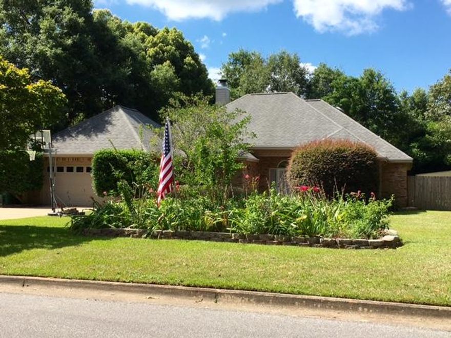 This beautiful brick home is a must see! This 3BR/2BA home is surrounded by mature oak trees and gorgeous landscaping. Features include an eat-in kitchen with bay window, formal dining room, open floor plan, 12 foot ceilings in the living room and foyer, and wood-burning fireplace. Elegant arches define the living room which, along with the dining room and bedrooms, boasts durable, like-new laminate flooring. The large master bedroom has a separate sitting area, and leads to the remodeled master bath, complete with whirl-pool tub, walk-in shower, separate vanities, walk-in closet, and linen closet. The two other bedrooms each have a walk-in closet and share a Jack-and-Jill bathroom. A large covered porch overlooks the spacious privacy fenced backyard.