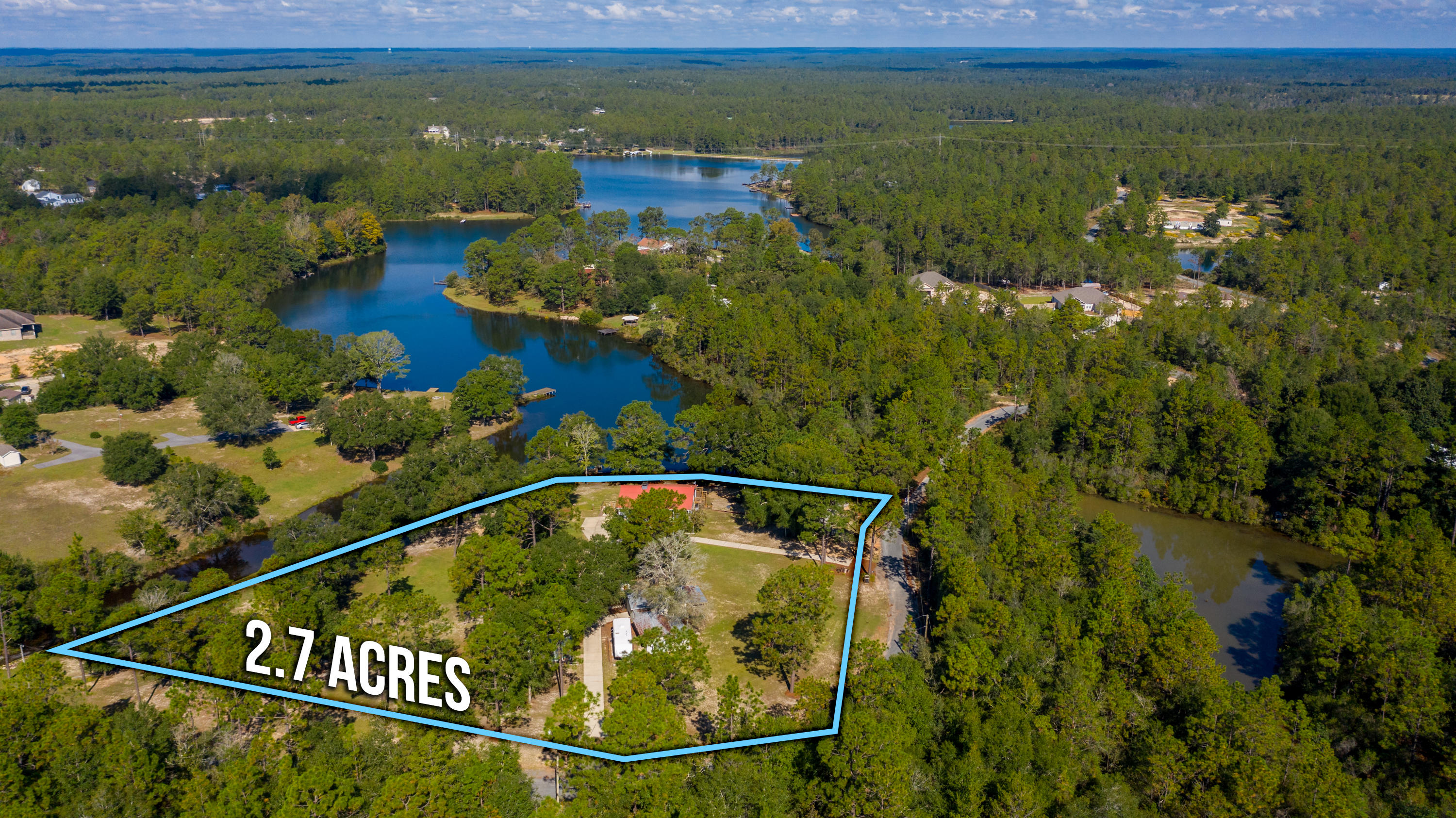 STUNNING WATERFRONT VIEWS!! Enjoy your morning coffee overlooking beautiful panoramic views of Mirror Lake! The meticulously well maintained home is located on 2.7 acres +/- w/ approximately 600' of water frontage. A rare find in this area! The home has been nicely renovated and features an inviting entry and nice sized living room. The beautiful farmhouse style kitchen boasts a center island, granite countertops and stainless steel appliances. Spacious dining area complete w/ lots of windows creating a great view of the lake and lots of natural light in this space. The two guest bedrooms and full bathroom are located upstairs. A huge deck located just off the dining area is the perfect space for entertaining your guests. Downstairs you will find the master suite complete w/ wood burning fireplace and large walk-in closets. Beautiful master bathroom features antique dresser w/ dual sinks and a large marble shower. Lots of nice rustic touches! Laundry room located downstairs as well. Located just outside of this area is a great porch and relaxation area. Beautiful hardwood trees flank this property. Enjoy fishing off your newly rebuilt dock - lake is stocked with bass, bream and other types of fish. The boardwalk/retaining wall, manual boat launch (pulley type system) and fire pit area are all great attributes to this spot. It truly is a retreat and spot for all the family get togethers for years to come... Up the hill you will find a 24'x28' workshop w/ single car garage door, 12'x24' fully enclosed storage area w/ 12'x20' covered area, potting shed and small art studio. A truly unique property! Make your appointment for a private tour today!