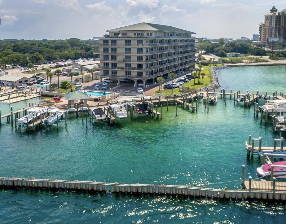 Spectacular views of Crab Island and Destin Pass from this spacious Boater's dream condo which includes deeded slip/lift and covered parking spot. Never a dull moment watching amazing sunsets, yachters ,sailors, dolphins, manatees, rays and fireworks all from your own huge balcony. Fish, swim or paddleboard near private marina.  Take a short walk to  several restaurants and community festivities. This spacious condominium boasts split floor plan, huge bed and bathrooms, granite counter tops, 10ft' ceilings and plenty of storage space. The boat slip is 20x40 along with paddleboard/kayak storage & gated/covered parking.