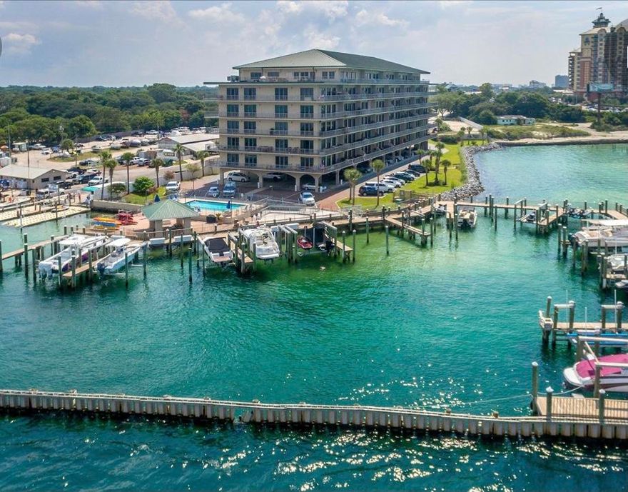 Spectacular views of Crab Island and Destin Pass from this spacious Boater's dream condo which includes deeded slip/lift and covered parking spot. Never a dull moment watching amazing sunsets, yachters ,sailors, dolphins, manatees, rays and fireworks all from your own huge balcony. Fish, swim or paddleboard near private marina.  Take a short walk to  several restaurants and community festivities. This spacious condominium boasts split floor plan, huge bed and bathrooms, granite counter tops, 10ft' ceilings and plenty of storage space. The boat slip is 20x40 along with paddleboard/kayak storage & gated/covered parking.