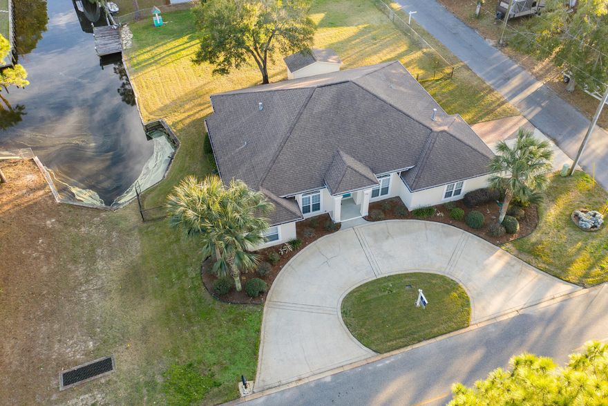 HUGE PRICE REDUCTION! Stunning canal front Davis Dunn custom home is ready to welcome you. Entering the spacious foyer, you will notice an office/formal living room (easily transformed to a 4th bedroom) on one side and dining room on the other. Continuing through you will enjoy the spacious living room with views of the canal and a cozy fireplace. Updated kitchen features breakfast bar, granite countertops, stainless appliances, gas stove, tile flooring and breakfast nook. The large master suite offers access to the lanai, large walk -in closet, spacious bathroom with double vanity, walk-in shower, separate tub, private toilet room and to compete this amazing suite is a built-in office space for those days you work from home.  This split plan has 2 guest bedrooms with a full bath, nice