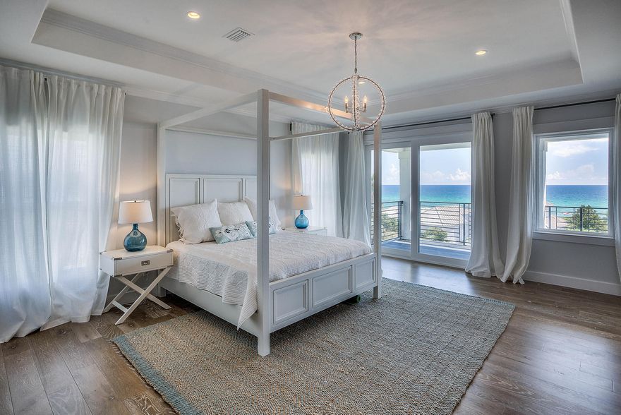 GORGEOUS GULF VIEWS in this NEWLY BUILT CUSTOM home that's BUILT TO LAST! Constructed w/ 2 EXTRA ROWS OF BLOCK WALLS for additional stability, SMOOTH TROWEL Stucco, STEEL Stem walls, SOLID interior special order doors, Standing Seam Roof for added wind resistance, PLUS upgraded windows & triple locking system on doors! This 6 bedroom home boasts beautiful GULF VIEWS from the 2nd & 3rd floors, 3 covered balconies w/ CUSTOM OUTDOOR RAILINGS to not obstruct views, 7'' classic grey, hand scraped HARDWOOD THROUGHOUT, & 8' glass sliders opening to balconies. The gorgeous KITCHEN W/ A VIEW IS A CHEF'S DREAM w/ PROFESSIONAL BUILT IN THERMADOR appliances, bright-white SHAKER STYLE cabinets, CUSTOM PANTRY, double sinks, 6 BURNER GAS STOVE w/ pot filler, and MACAUBAS QUARTZITE throughout kitchen &