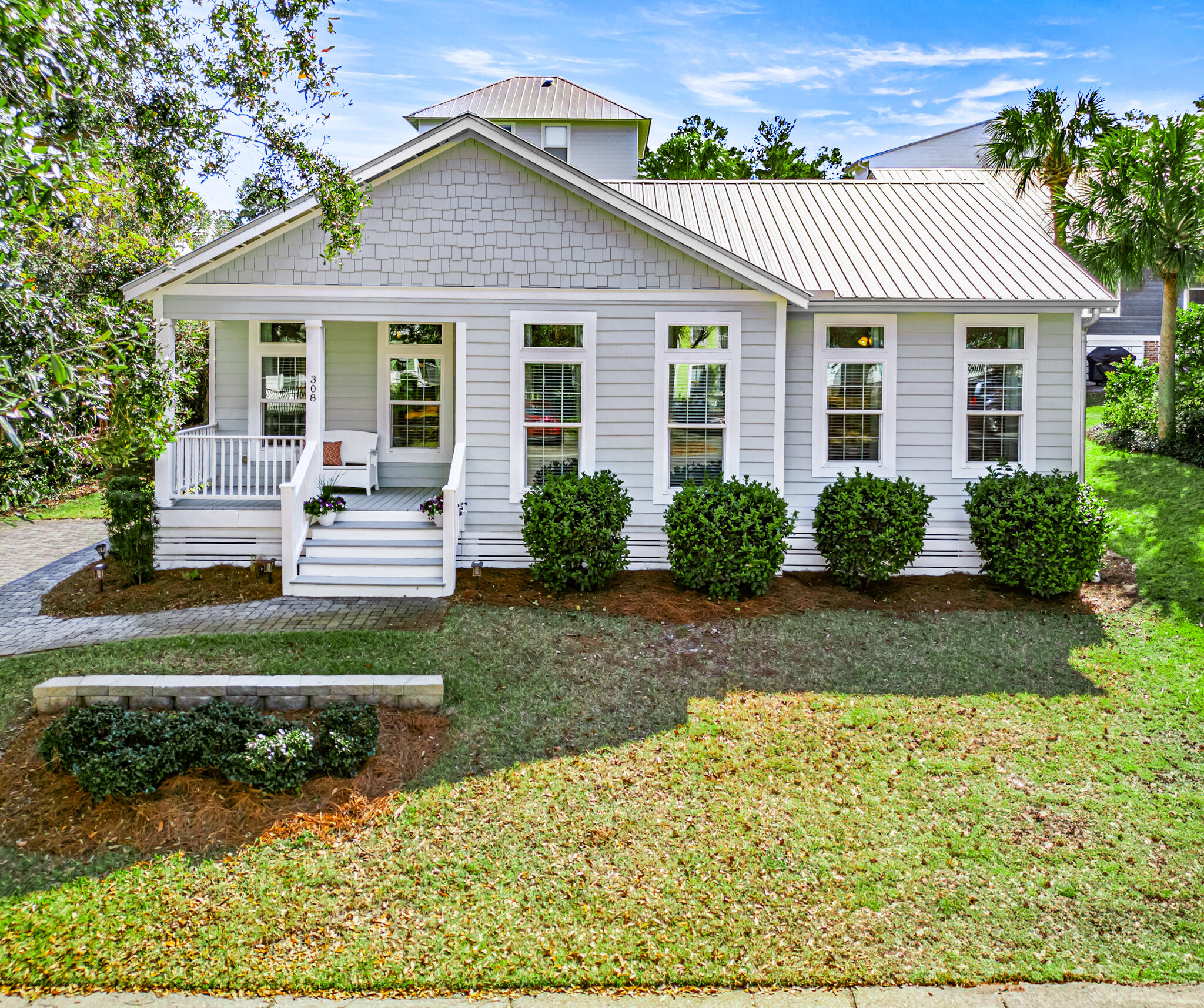 Discover your dream beach retreat located less than 1/2 mile to the beach in the gated community of the Village at Blue Mountain Beach. As you walk up the brick paver walkway you'll be pleased with the landscape and inviting front porch- perfect to sit and relax. This well-maintained home is a hard to find single story making it easy to maintain and navigate. Step inside to an open-concept living space with bright, airy interiors, large windows with transoms, and tasteful finishes. The large kitchen features stainless steel appliances, quartz countertops, lots of cabinets, and a center island making it a chef's delight. A paver patio is located off the kitchen making it easy to entertain and dine alfresco. The spacious master suite boasts an en-suite bath with large walk-in shower and quartz double vanities. The other end of the split floorplan offers a hall bath and two additional large bedrooms one with twin/twin bunks and queen bed and the other with a king provide plenty of room for family or guests. The Village has many amenities including a large pool, fitness center, putting green, bocce ball court, and shuffle board courts. You'll also be pleased with the commercial additions including Mimmo's Italian restaurant, 30A coffee shop, ice cream shop, and smoothie bar just to name a few. This home is an ideal getaway, investment, or full-time residence. Don't miss your chance to own a piece of paradise. Schedule your showing today!