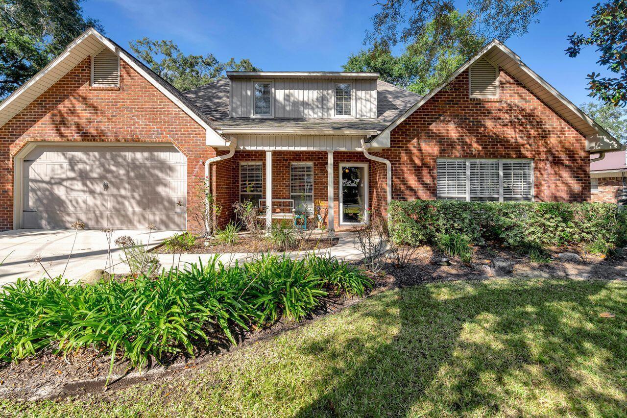 Located right outside Eglin Air Force Base's East Gate, within walking distance to Addie R. Lewis School, and within 1/2 mile to Florida Park which has a boat launch and playground. Built in 2012, this four bedroom, 3 bath home features two bedrooms and two full baths downstairs and the additional two bedrooms and bath upstairs. Beautifully set on 1/4 of an acre with lots of lovely mature trees and fenced-in large back yard. Inside you will find rich wood floors, granite counters, stainless steel appliances and a custom wine bar. The main floor also features a formal dining room, separate laundry room and large living room. Large master bath has double vanities and a large walk-in granite shower with soaking tub. Covered front porch and the screened back porch are click for