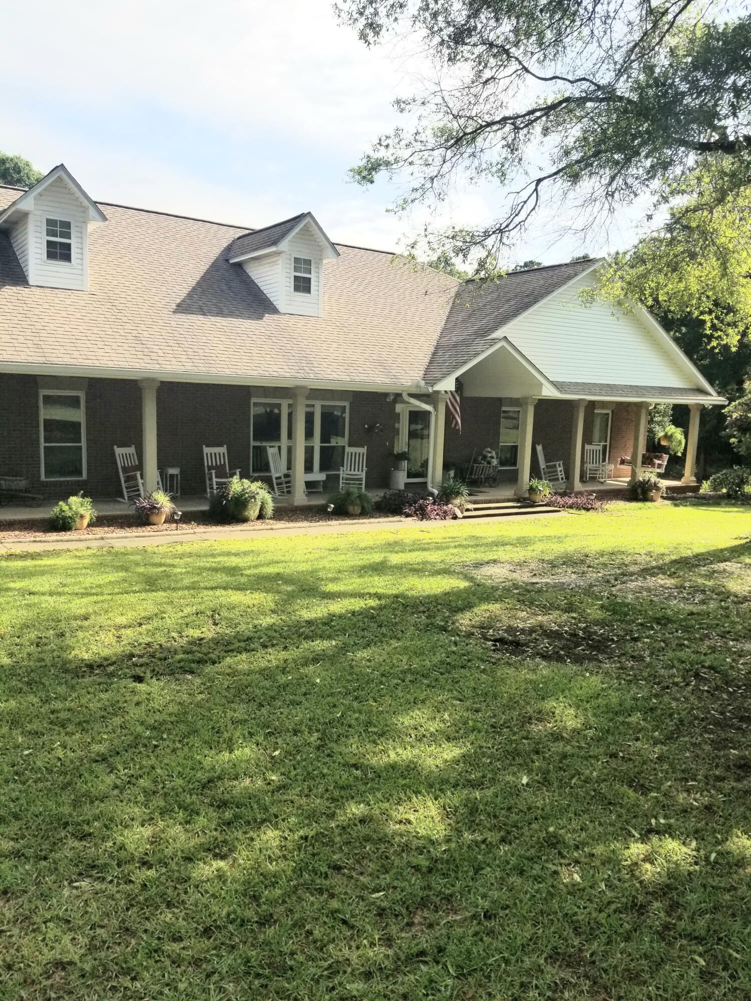 Beautiful property with fruit trees, hunting right out the back door, in-law quarters, carports and garden sheds. Pantry, walk-in closets, tile floors throughout, central vac system. Covered back porch, carport. Plenty of room to grow in this spacious well kept home!