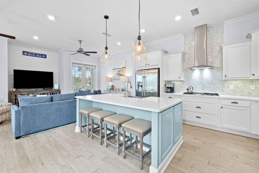 Step into a world of seamless sophistication in this beautiful two-story townhome. Backing up to forest, this pristine condo comes fully furnished and move-in ready. A paved driveway and two-car garage provide ample parking for cars, bikes and a golf cart, with generous accommodations spread over two floors. Relax in the first-floor sitting room, enjoying gentle sea breezes and leafy views through a series of windows and French doors that open onto the balcony. White decor and blond LVP wood flooring create a light and airy ambiance. The sleek open kitchen is practical yet well designed, with a large island encouraging social conversation. Stainless steel appliances, a chic tile backsplash and a useful pantry provide everything you need to serve imaginative meals in the dedicated dining area. To the rear of the unit, a decked balcony offers an outdoor space for enjoying fresh air and alfresco dining with tree-lined views. Recent updates to the home are evident in the new shiplap walls that extend into the dining room and upstairs. New furniture makes this home completely turnkey as a second home with rental potential. Stairs lead to two large bedrooms plus a bunk room, all served by immaculate bathrooms. This townhome offers spacious accommodation that is priced to sell and offers a superb opportunity to enjoy 30A living. Suitable as a full-time residence or vacation rental, it is close to two resort-style pools with zero entry access and is right across the street from the Big Chill dining and entertainment hub. A seasonal shuttle carries you safely to the white sandy beach. Nearby Rosemary Beach and Seaside, Florida, are the main hubs for dining, boutique shopping and entertaining while Camp Helen State Park and Point Washington State Forest offer miles of nature trails for hiking, biking and outdoor recreation.