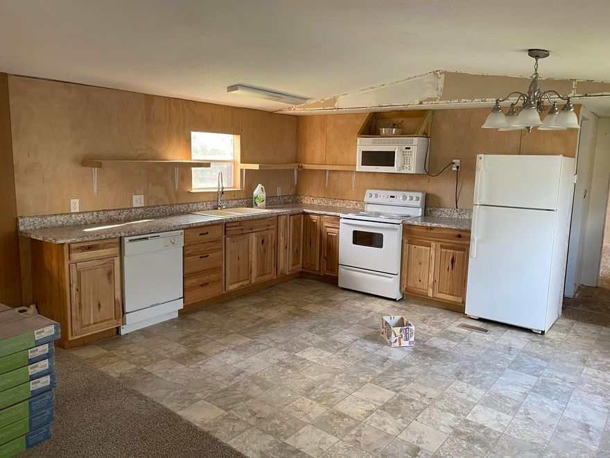 Super potential. Quiet street and near downtown. Newer style layout on a large private lot with pond in back. Exterior in decent shape and partially remodeled. Metal roof, new water heater in 2019, central HVAC serviced in 2019, and newer kitchen appliances. Shed doesn't convey. Won't qualify for most loans.