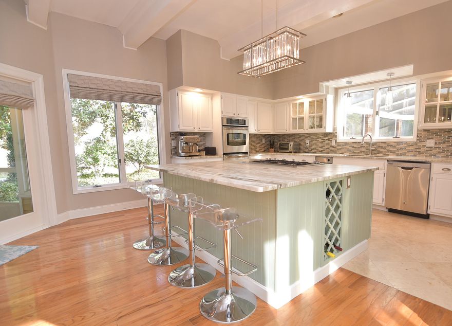 This 4 bedroom and 4.5 bathroom custom built home situated on the 9th hole of the Bluewater Bay golf course is stunning! With gorgeous views of the Bay in the front and your own private oasis in the back, this home is sure to please. Seller has made almost $70,000 in improvements within the last 9 months and it shows! Upon entering through the double front doors, you will be amazed by the impressive curved staircase, 25' ceiling, and marble floors. The kitchen features granite countertops, a beautiful backsplash, a wine cellar, double ovens, and an oversized island with gas range. The family room boasts a brick, wood-burning fireplace with hearth and an oversized mantle. A separate living area overlooks the pool and is a great place to sit and read or have your morning coffee.