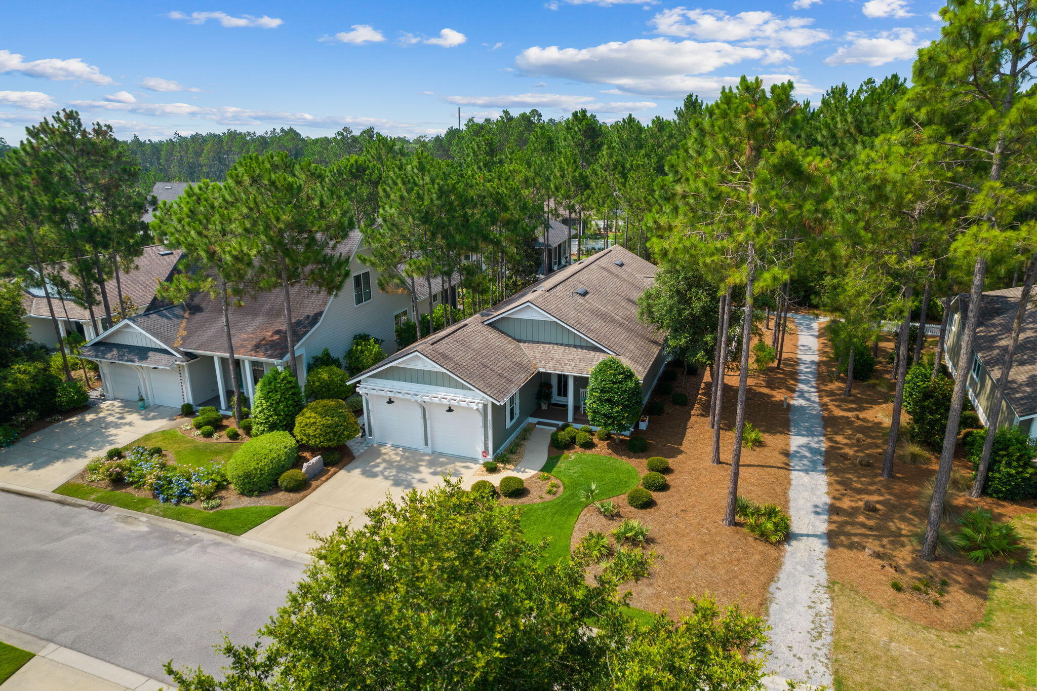 Immaculate 1 story Bayberry by Huff Homes, a true gem nestled on a beautiful lot that backs onto a stunning Nature Preserve. This remarkable property boasts a prime location in Watersound Origins. It's situated next to a serene walking path & featuring a fenced backyard, therefore, offering a level of privacy that truly feels like a sanctuary. Step inside and be greeted by an inviting open floor plan that showcases the home's charm. With 3 bedrooms and 3 baths, there is ample space for comfortable living. The 9' ceilings throughout create an airy and spacious atmosphere. The attention to detail is evident with thick crown molding, luxurious LVP flooring (no carpet), & elegant quartz countertops. This home comes with a range of extras that enhance its appeal. Plantation shutters add a touch of elegance, while the Generac generator provides peace of mind during power outages. The Centricon termite system ensures the property remains protected, and the gutters help maintain the exterior; which was freshly painted in 2022. The 2-car garage features a painted floor and an exterior door that leads to a charming paver path. The primary room is a true retreat, offering a generous space with an en suite bathroom. The double vanity sinks, walk-in shower, and oversized closet provide both functionality and comfort. This well-designed kitchen is perfect for hosting guests and creating memorable experiences. The center island serves as a focal point and provides ample space for food preparation and serving.
Adjacent to the center island, you'll find a convenient dry bar area. This feature adds a touch of elegance to your entertaining space and allows you to showcase your favorite beverages and glassware. Whether you're mixing cocktails or serving refreshments, this dry bar area makes entertaining a breeze. Enjoy the outdoors in style with a screened porch and a paver patio that overlook yet another scenic walking path and the breathtaking Nature Preserve. For those who love to grill, the concrete pad with a dedicated gas line is a dream come true. This home truly offers a serene & luxurious living experience. Don't miss your chance to turn this house into your dream home. *Professional videos coming soon*