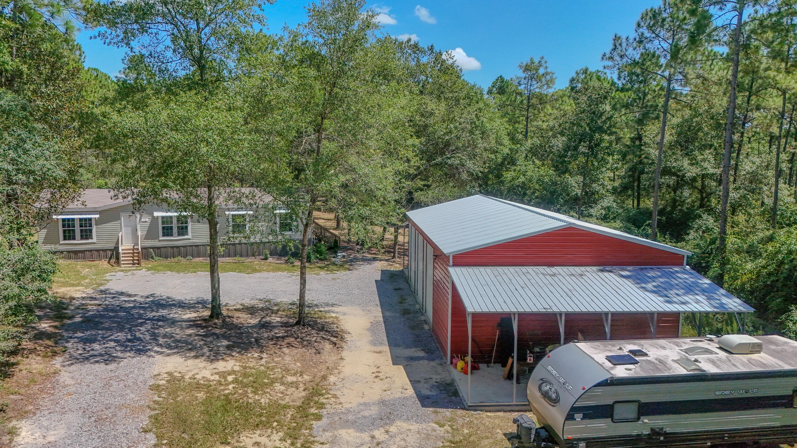 2023 home; 30x50 3-bay garage/shop (additional 10x30 covered parking on each side); 12x24 finished shed w/ac for storage/office...all on 10.14 ac. Walton Plantation is a privately held North Walton County gated community for outdoor & hunting enthusiasts that includes 6900 original acres with 145 privately owned parcels. As a property owner you have access to extensive amenities including approximately 2500 acres, miles of professionally maintained dirt roads, a rustic open-air chapel, public restrooms, ponds for fishing, a community garden, horse riding & ATV riding trails and approximately 300 yd. shooting range. Owners also have the option to join the hunting club for an additional $500 annual fee that allows hunting on approximately 2000 additional acres w/in the community. Must see!!