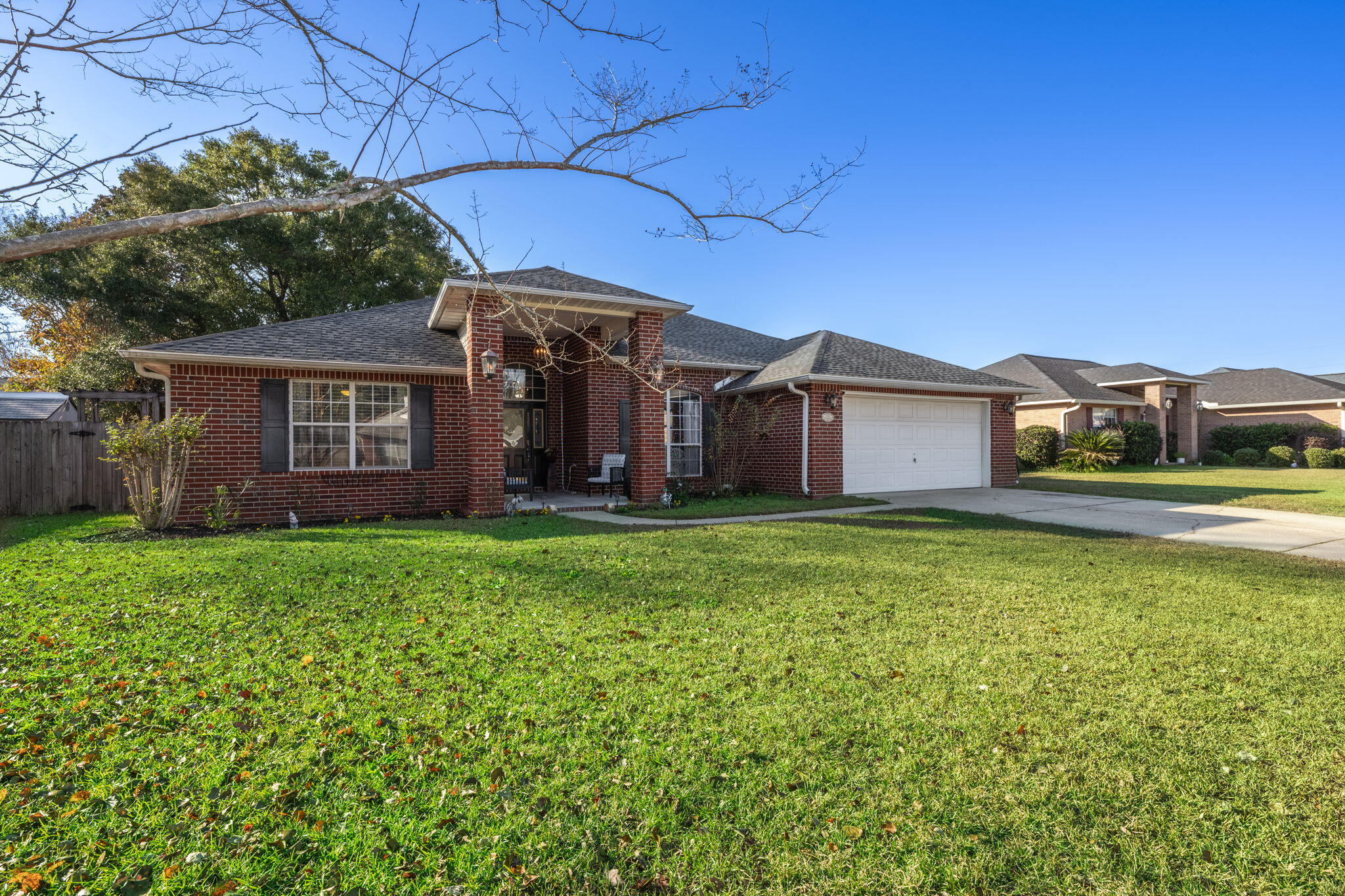 Welcome to this charming 4-bedroom, 2-bathroom brick home in the heart of Pace, Florida! Freshly painted throughout with a brand-new roof, this home offers a perfect combination of comfort and style. The cozy kitchen features quartz countertops, stainless steel appliances, rustic-style cabinets and a breakfast nook, ideal for casual meals. A formal dining room adds an elegant touch, perfect for entertaining or family dinners. The living room, complete with a cozy fireplace, features high ceilings that enhance the open and airy feel of the space.The primary suite is thoughtfully located on the opposite side of the home for added privacy, and boasts a spacious bathroom with a garden tub, stand-up shower, double vanity, and walk-in closet. Three additional bedrooms and one bath are conveni ently situated on the other side of the home, ideal for family or guests. Step outside to the covered patio that leads to the spacious backyard complete with mature trees, a fire pit, and a shed for extra storage. Hardwood floors flow throughout the home, and the oversized garage offers plenty of space for vehicles and storage. With its serene setting and modern updates, this home is perfect for those seeking both style and functionality in a peaceful Pace neighborhoo