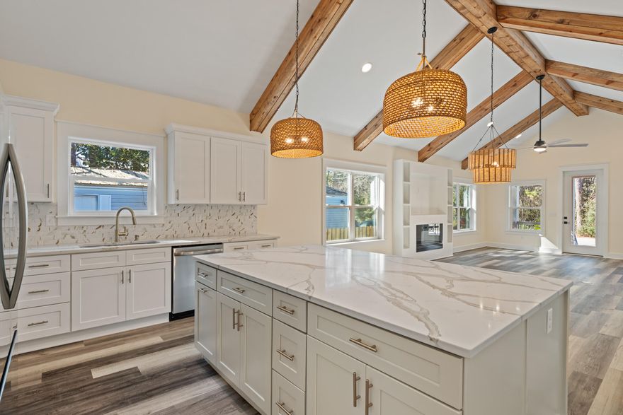 No HOA! Experience investment and relaxing coastal living in this brand-new beach home! Perfectly positioned near Choctawhatchee Bay and the pristine white sands of the Emerald Coast. Just moments from boating access at Cessna Landing and minutes from the Gulf, this New Built, offers an exceptional balance of luxury, lifestyle, and location.The interior is thoughtfully curated with vaulted ceilings, exposed wood beams, and an open-concept design that seamlessly connects the living, dining, and kitchen spaces. The chef-inspired kitchen features quartz countertops and soft-close cabinetry, while the living room invites relaxation with a warm fireplace and inviting coastal ambiance.