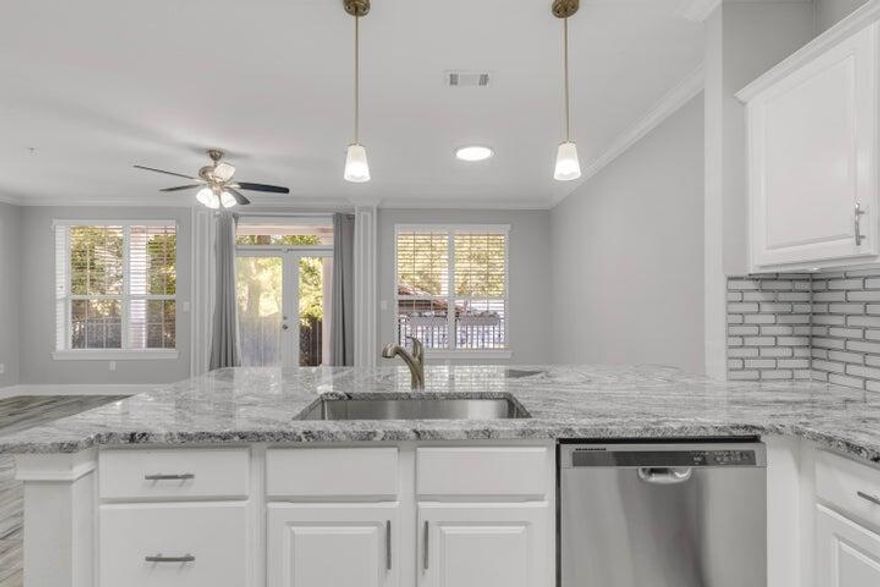 Beautifully updated French Quarter condo with an Assumable 3.5% interest rate VA Loan! Seller says, Make an Offer! 2 spacious bedrooms w/walk-in closets and 2 full bathrooms, & a Flex room! Stone countertops, tile backsplash, ceramic wood-look floors, and crown molding throughout makes this condo standout from the others! Open concept floorplan leads to French doors to your private 200 sq. foot balcony with views of the sound or the fireworks and bands playing at The Landing. Return home after exploring downtown with ease by taking the elevator to your digital keyless entry! You'll love the well-equipped gym, on-site owners storage, dedicated parking, and deeded waterfront access! Nearby amenities-shopping, boating, pickleball, dining, biking, fishing, playground, and all of downtown!
