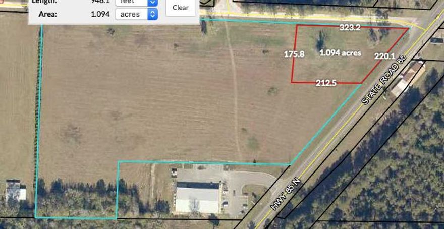 Mixed use acreage with 220 ft of Hwy 85 frontage. Flat, cleared land. Utilities available at street. Additional acreage available. Just south of Laurel Hill School entry, just north of Dollar General.