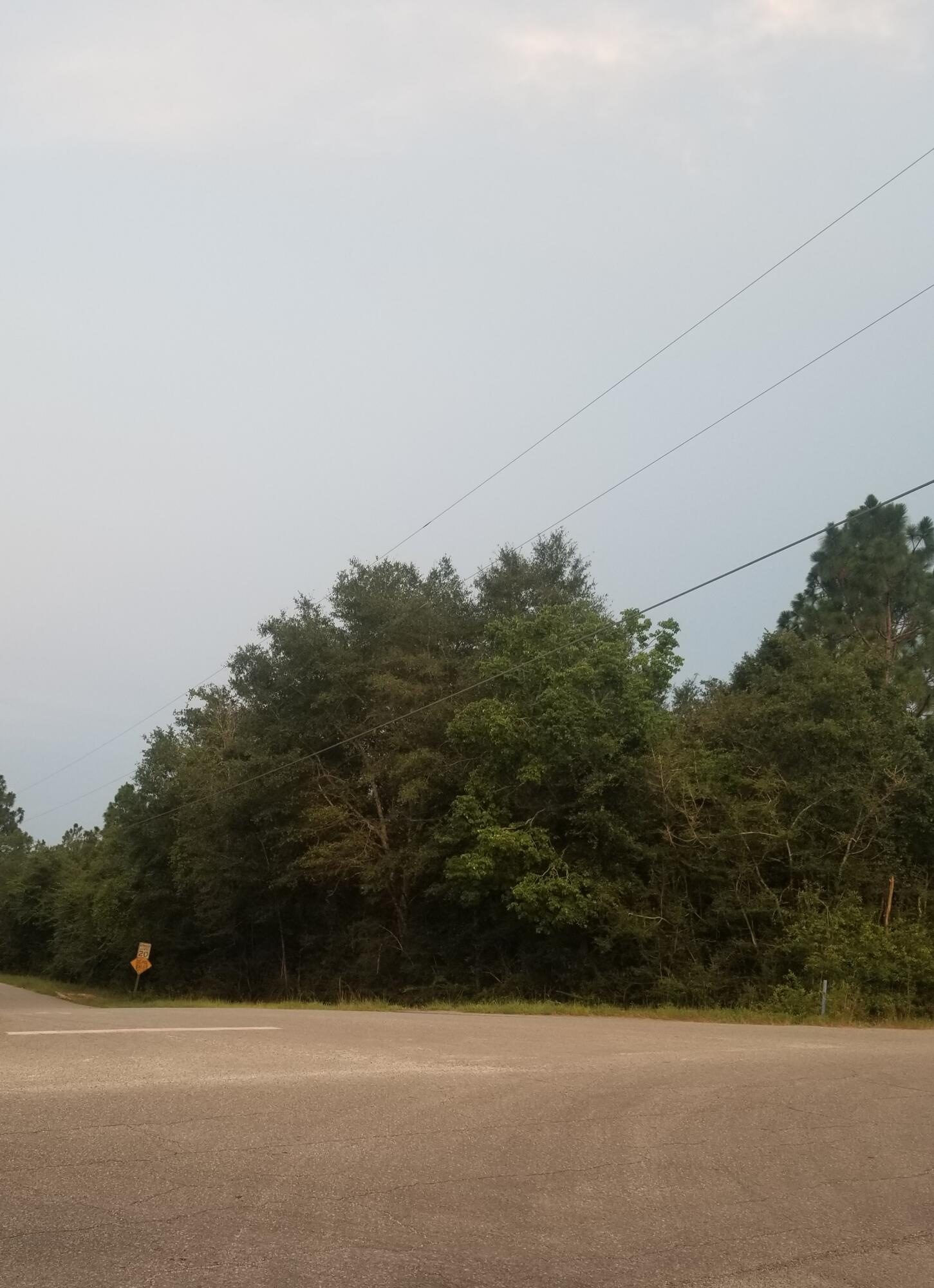 THIS IS A NICE WOODED LOT ON THE CORNER, BOTH ROADS PAVED.