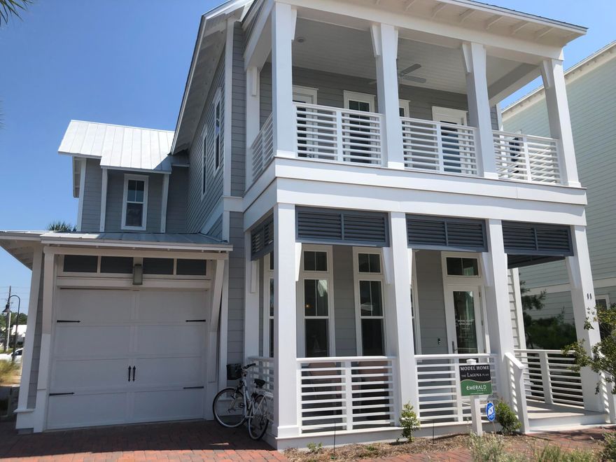 The Laguna plan feautres HardiPlank, Metal roof and vinyl impact resistant windows. As you drive up to this home you find brick pavers in the driveway and walkway. This plan has a large great room as you enter this home and kitchen with center island. The interior of this home has Hardwood floors on the main level, upstairs hallway and bedrooms, tile in the wet areas, smooth finish ceilings, brushed nickel hardware and beautiful interior 8' doors. The covered porches have ceiling fans and can lighting fixtures. This home has two large bedroom suites on each level, with large walk-in closets and shower with frameless glass door, and 2 additional bedrooms on second level.