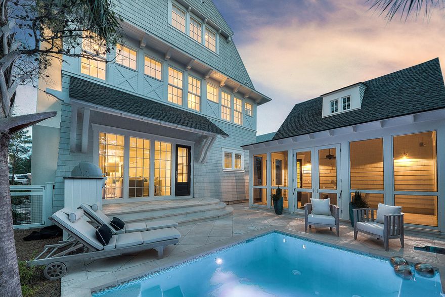 This stunning new construction home in beautiful WaterSound Beach is the epitome of luxury beach living. Designed by Dungan Nequette and built by Regal Stephens, nothing is left out in the composition of this unique home. The architecture is inspired by maritime influences, contemporary beach style, and classic 30A charm. Enjoy WaterSound Beach life alfresco and privacy in the screened porch and spacious swimming pool area that boasts fire rock pavers, an elegant waterfall feature, and a built-in Wolf grill over looking Deer Lake State Park. The state forest provides this home with tranquil seclusion and magnificent views. Inside, the state-of-the-art kitchen features double Wolf and Sub-Zero appliances with two center islands, jet black Nero Martinez marble countertops. The true..