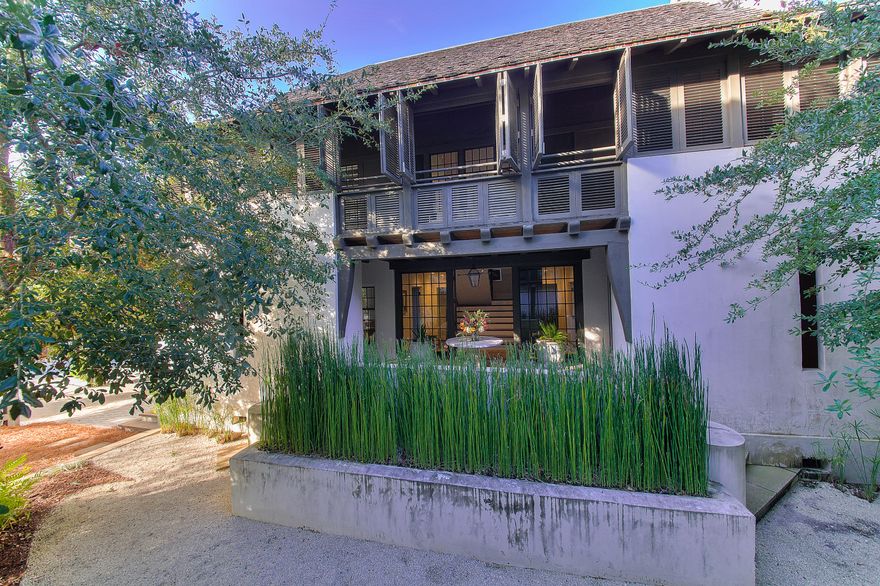This exceptional Rosemary Beach home located south of 30A on Spanish Town Lane is by noted architect Ruard Veltman of Charlotte, N.C. At over 2900 square feet, this Dutch-influence design is a testament to architectural style meeting comfortable livability. Note from the exterior the curving masonry walls, vine draped arbors, cedar shake roof, shuttered porches, copper gutters, and delightfully sized gas lanterns; all intended to excite the senses AND enhance the quality of this beautiful home. Enter to find three bedrooms on the first floor; a beautifully appointed master suite, as well as two guest rooms with private baths. Ascend the whimsically designed staircase to the second level living area. There is an open feel to the living room, with a high arched ceiling, ... (see next page