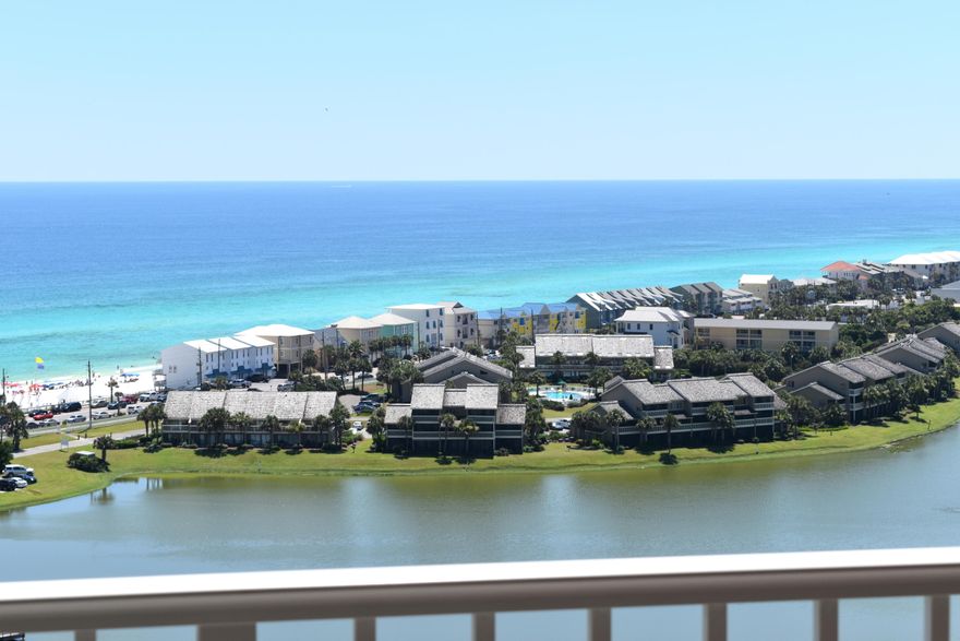 HIGH ABOVE THE CROWD  IN EVERY WAY! This well-decorated two bedroom, two bath plus bunks unit features awesome views of the gulf, lake, & even the bay. Relax on the balcony while watching the sunsets & enjoying your favorite beverage. The condo has beautiful wood laminate floors throughout the living area & bedrooms. The entry, bathrooms, & kitchen are tile. The kitchen has pretty granite counter tops, stainless steel appliances, & natural wood cabinets. The master bedroom has a king bed, access to the balcony, & showcases beautiful gulf views. The second bedroom has one double bed & one single bed making it more versatile for various ages of guests & renters. Of course the children are delighted with the bunk beds. Other amenities include a laundry room with stackable washer &