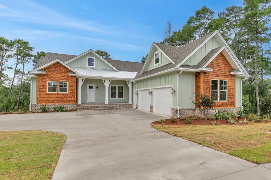 Back on the market at no fault to sellers! This exquisite new home nestled on a prime lot in Deer Moss Creek features 3167 sq ft with 4 bedrooms, 4 baths, a storm room, plus a rec room! The exterior will boast stunning cedar shake and  metal accents, gas copper lanterns, and cypress porch columns. The gorgeous front porch with wood ceiling welcomes you to a spacious foyer. The open floor plan leads you to a large family room that features a stunning fireplace and a breathtaking view of your natural landscape. The beautiful kitchen is tailored for hosting, with quartz countertops and stainless steel appliances. The spacious master bedroom and one bedroom/study are conveniently situated on the first floor. The fabulous back porch awaits you for your morning coffee or your glass of wine.