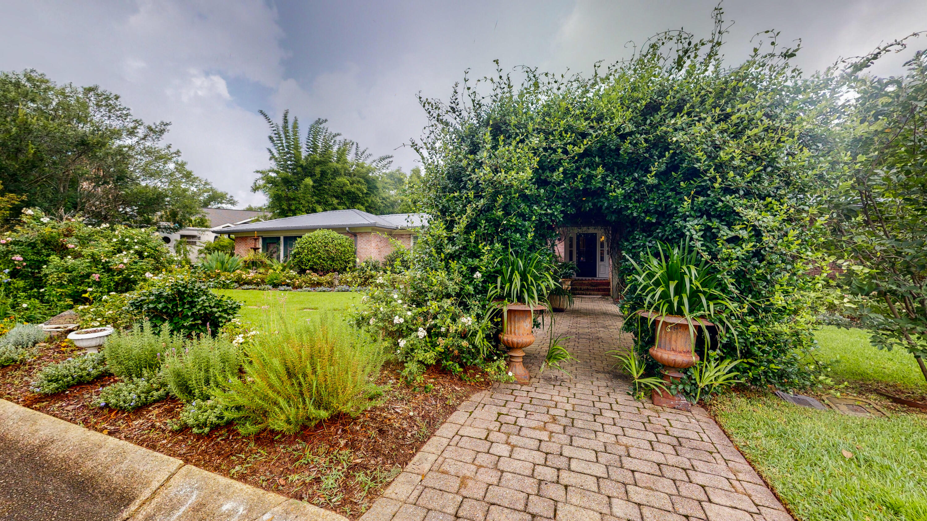 Extraordinary 3 Bedroom 3 Bath renovated brick Midcentury Ranch in the much sought after East Hill Neighborhood of Pensacola. Eclectic design elements bring together the old with the new and marry modern elements with beautiful antiques to create the perfect timeless haven.Each room is flooded with natural light from large windows boasting Kravitz Velvet Drapes and custom fit shades. The original oak hardwood floors have been refinished through the home giving a cohesive feel as you transition from room to room, Each living space has been customized with Farrows and Ball Paint as well as luxury high end wallpaper from Schumacher, Osborne & Little, Christian Lacroix, and Coleman. Custom closet systems are in each bedroom. All bathrooms have been recently remodeled.