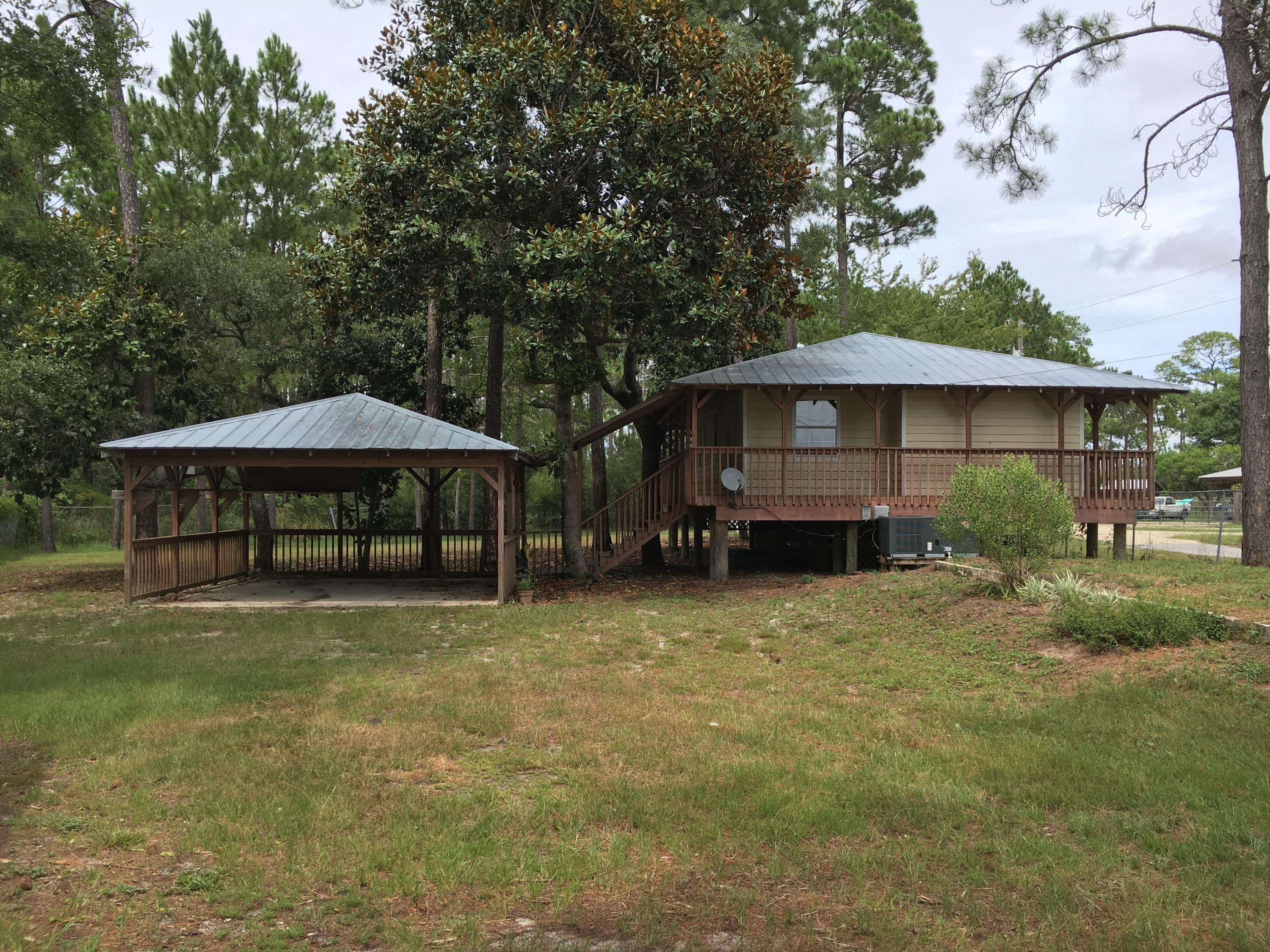 Great property in Basin Bayou with canal access to bayou and bay. One bedroom 1 1/2 bath house on pilings with two car carport. Wrap around covered deck 3/4 way around the house. 10 x 20 Storage building in rear of property. Additional building has open living space, partial kitchen and a bathroom that with a little work could be a livable space. Additional one car garage attached. Directly across the highway from Nick's Seafood Restaurant and the bay. This property has unlimited potential.