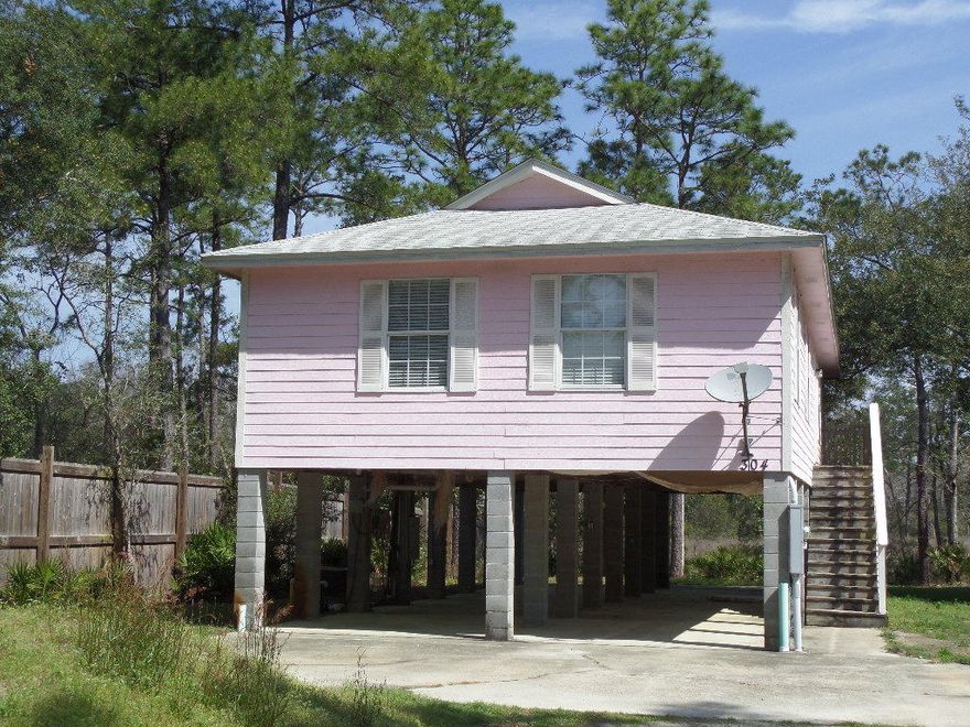 Peaceful canal front retreat in Freeport. This charming 3 bedroom 2 bath Florida cottage is built up on concrete piers to maximize the beautiful canal views that stretch out behind the home. The living areas are at the back of the home so they also enjoy the great views. A spacious deck off of the living & dining areas offers even more living space and is perfect for entertaining or just relaxing and enjoying the peace and quiet. There is tile flooring throughout the main living area and baths. The bedrooms have laminate flooring. All rooms are nice and bright. There is also a large carport area under the home. This location, just off of Hwy 331, is great and is just a short drive to the beaches, restaurants, shopping, hospital, schools and more.