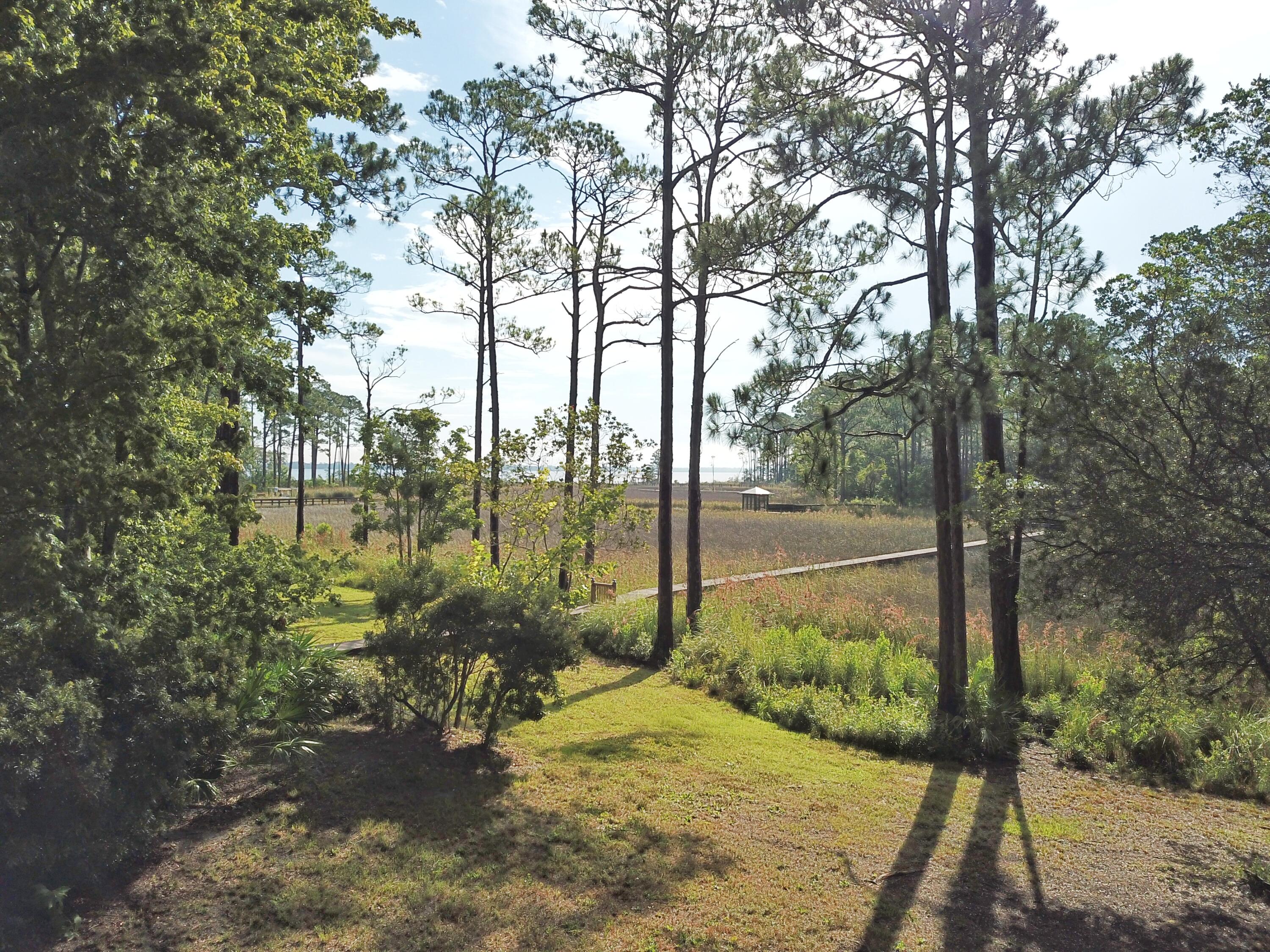 WATERFRONT lot with small storage building on 84 ft of waterfront, overlooking McQuage Bayou in Pt Washington, with access to the Bay. Build one large waterfront home with commanding views and privacy and have ample yard, or hold without building. No buildout times, no hoa, no dues. Beautiful views across the bayou and bay views too. Why buy on 30A when you can retreat to waterfront living at a fraction of the price and drive 4 miles to Grayton Beach, WaterColor and Seaside. Mostly state forest along the way.