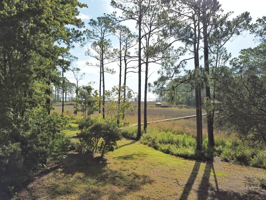WATERFRONT lot with small storage building on 84 ft of waterfront, overlooking McQuage Bayou in Pt Washington, with access to the Bay. Build one large waterfront home with commanding views and privacy and have ample yard, or hold without building. No buildout times, no hoa, no dues. Beautiful views across the bayou and bay views too. Why buy on 30A when you can retreat to waterfront living at a fraction of the price and drive 4 miles to Grayton Beach, WaterColor and Seaside. Mostly state forest along the way.