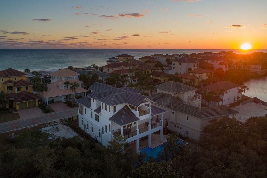 Newly built and primely positioned, this exemplary coastal retreat is perfectly situated to capture gulf views & masterfully configured providing unparalleled amenities including a watermark-built private resort style pool area complete with a sunken swim-up bar as well as an adjoining spa, in-pool concrete picnic table & covered outdoor summer kitchen. Located second tier in the exclusive gated neighborhood of Destiny, this newly built custom home was thoughtfully designed to provide exceptional gulf views and maximize functionality with finely appointed coastal contemporary finishes while affording optimal comfort & living space.
