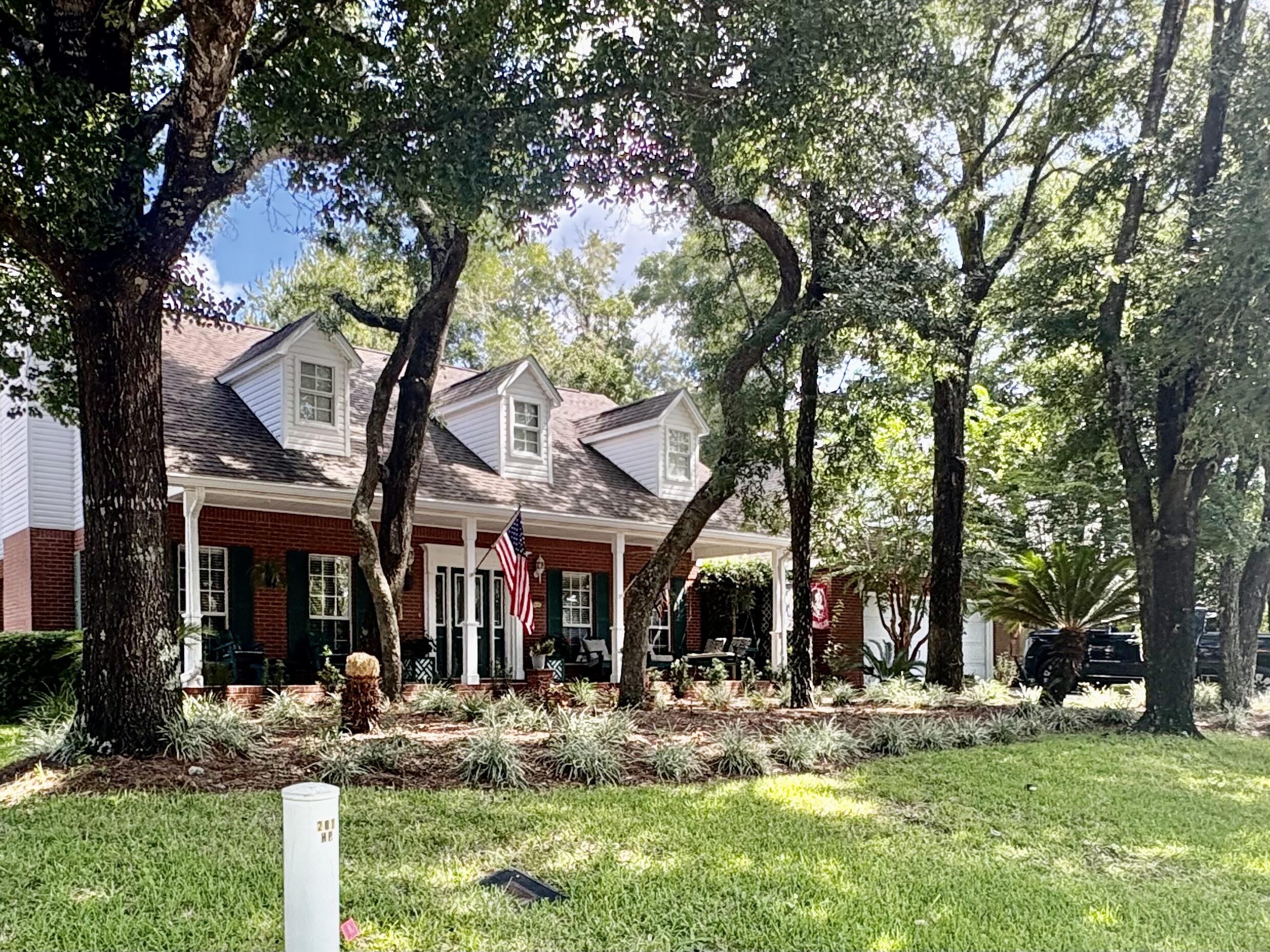 This 4-bedroom, 2.5-bath home offering approximately 3,118 sq. ft. of thoughtfully designed living space. Perfectly situated near top-rated schools, white-sand beaches, shopping, and military bases, this home blends classic charm with modern amenities. Step inside to find high ceilings, a welcoming wood-burning fireplace, and an open kitchen with stainless steel appliances--ideal for both daily living and entertaining. The spacious dining and living rooms provide a natural flow for gatherings, while the large laundry room and extra-large two-car garage add everyday convenience. The second story is a private retreat featuring a game room, office, small bar area, bedroom, full bath, hallway, and multiple storage spaces, all serviced by its own AC
